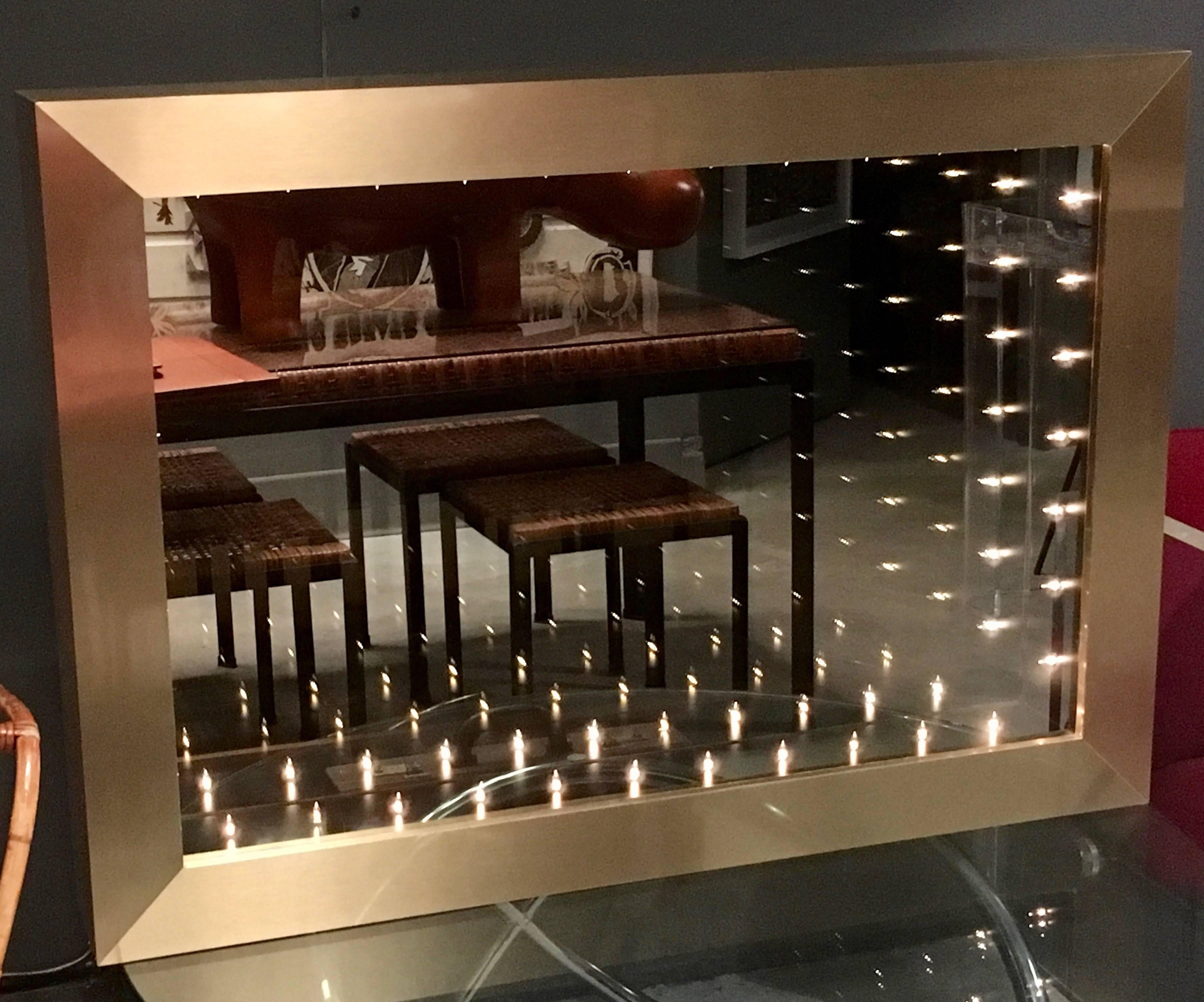 Massive brass rectangular infinity mirror by Merit. Brass frame mirror looks great off as well as an ambient light and piece of art while illuminated. 

Custom sizes and finishes available.