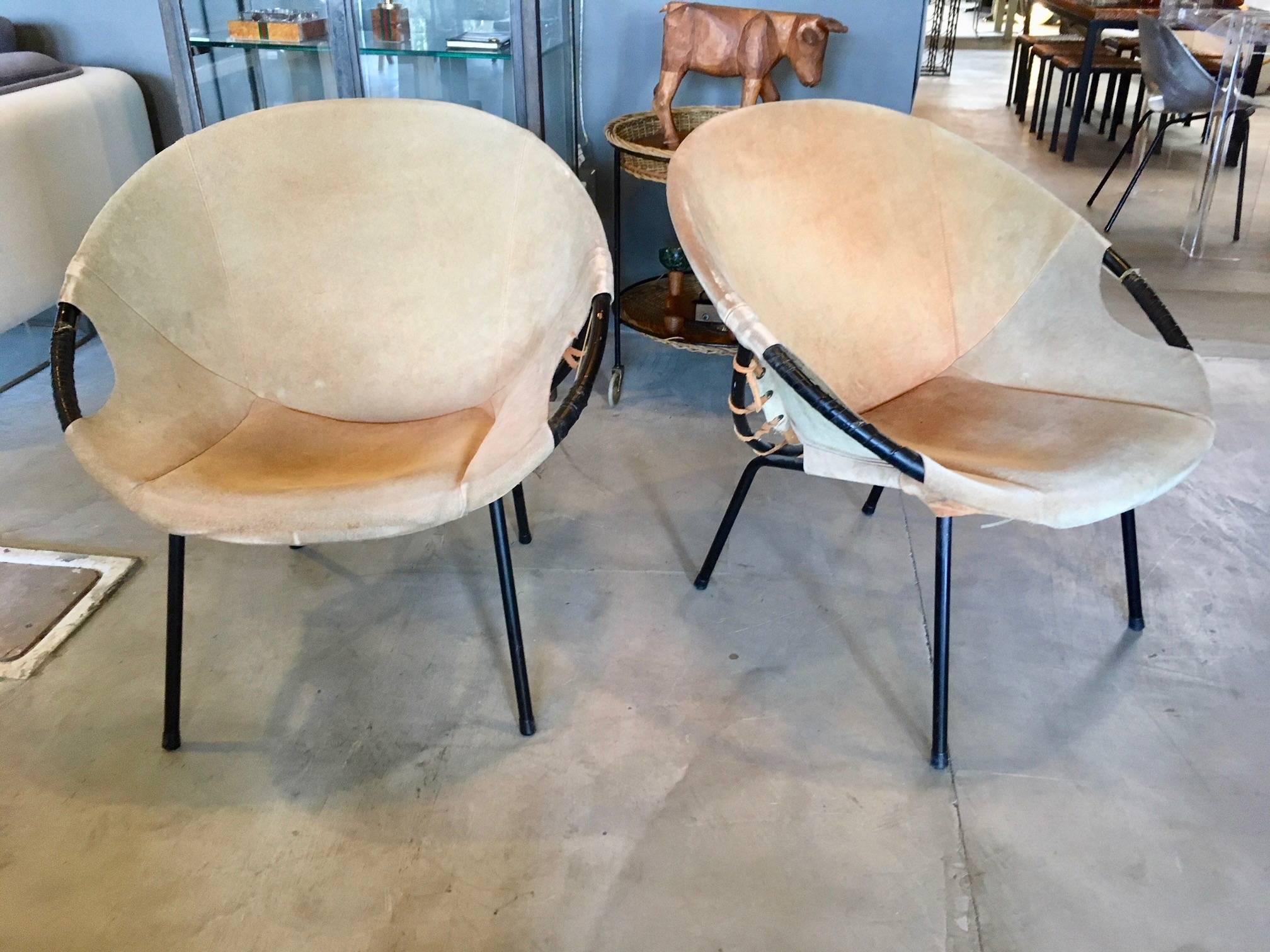 Gorgeous pair of suede scoop chairs. Metal frame with wrapped arms and suede seat. Classic design. Good vintage condition. Hard to find a matching pair. Extremely comfortable.

Two single chairs available in separate listings. One red, one