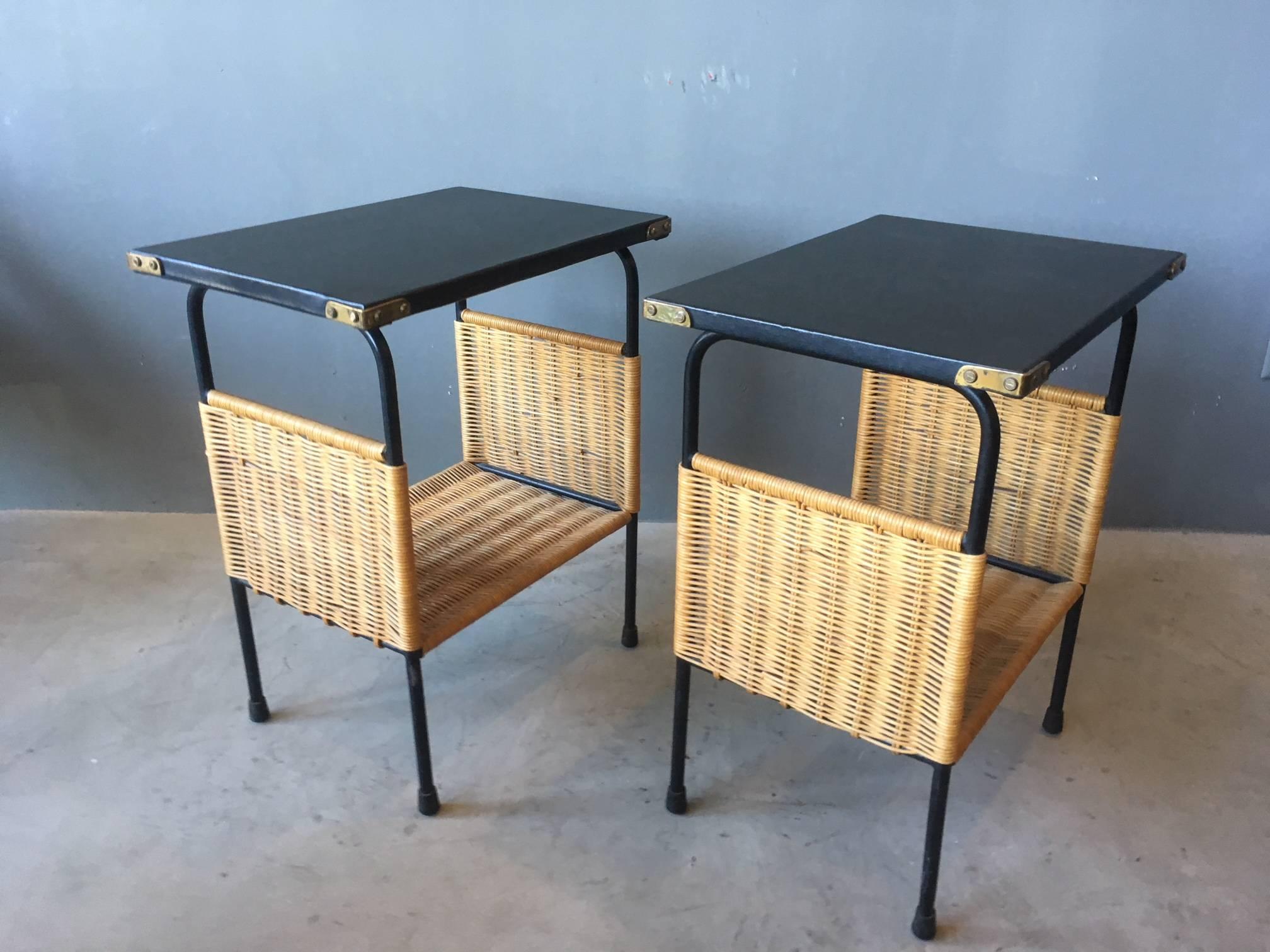 Stunning pair of leather and wicker side tables by Jacques Adnet. Iron legs with leather top and brass hardware. Wicker shelf. Perfect as nightstands or side tables. Never seen before. In extremely good, original condition. Gorgeous design.

Over 75