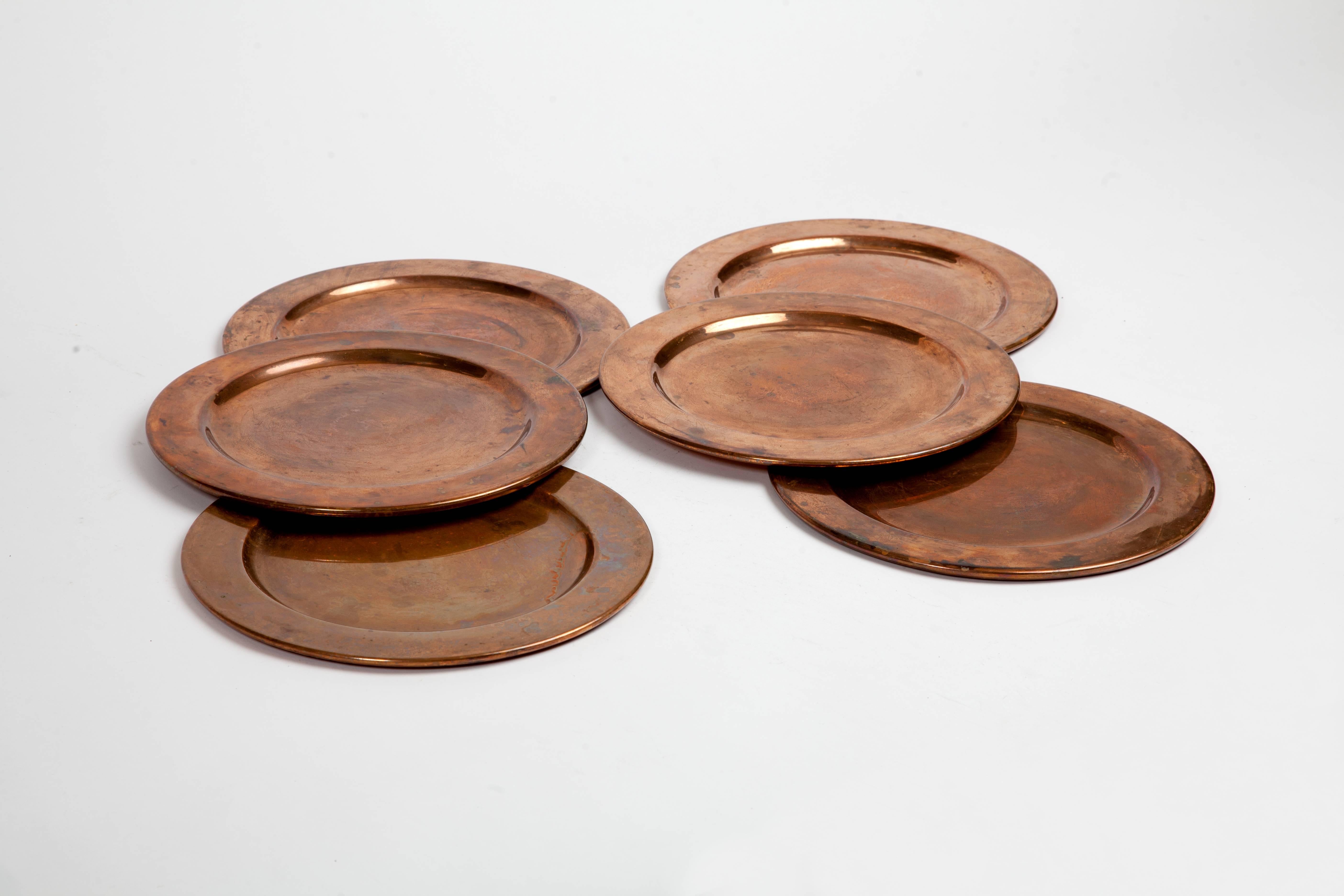 Collection of six solid copper dinner plates.