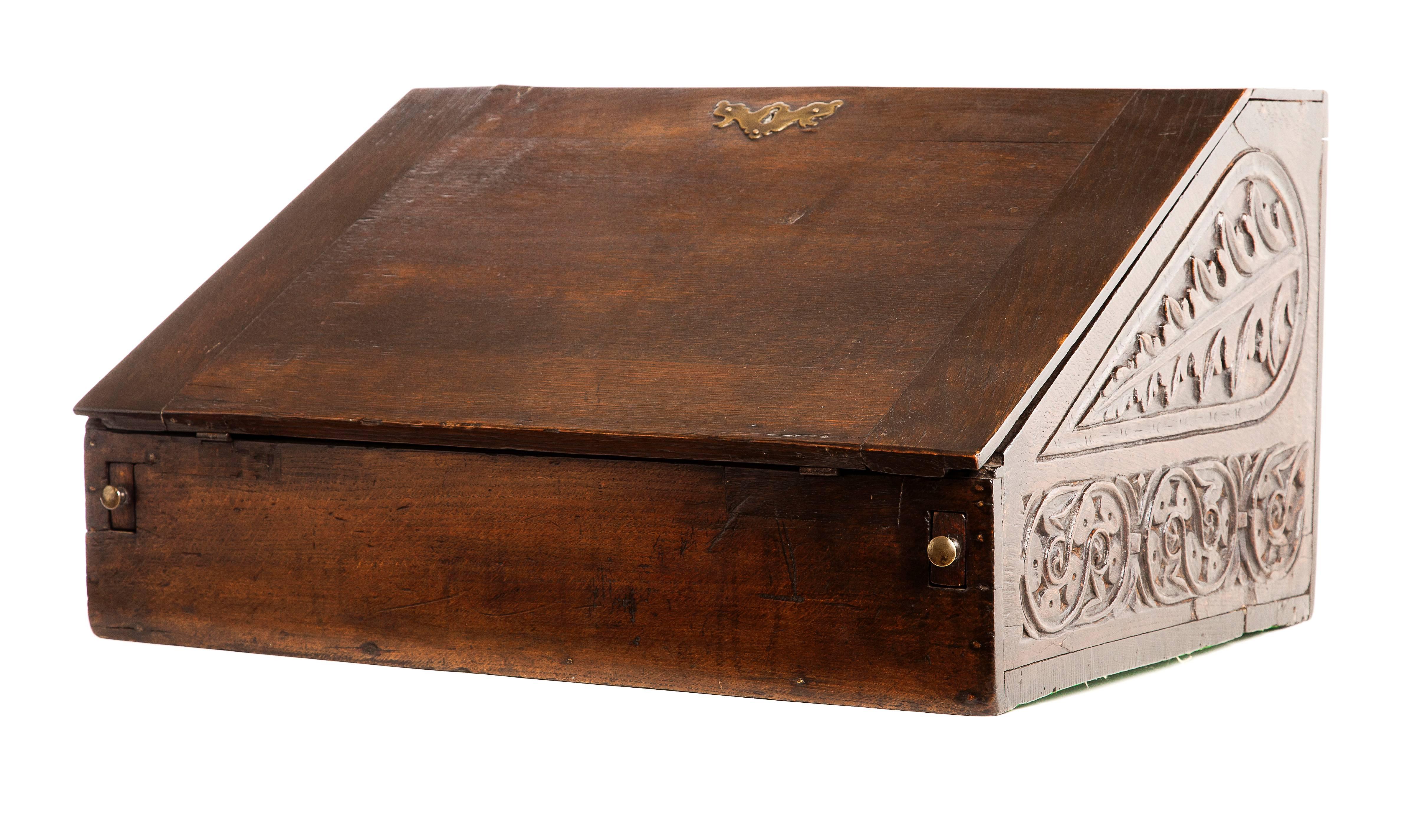 19th century English writing slope. Walnut with carved sides, five interior drawers and brass lock and pulls.