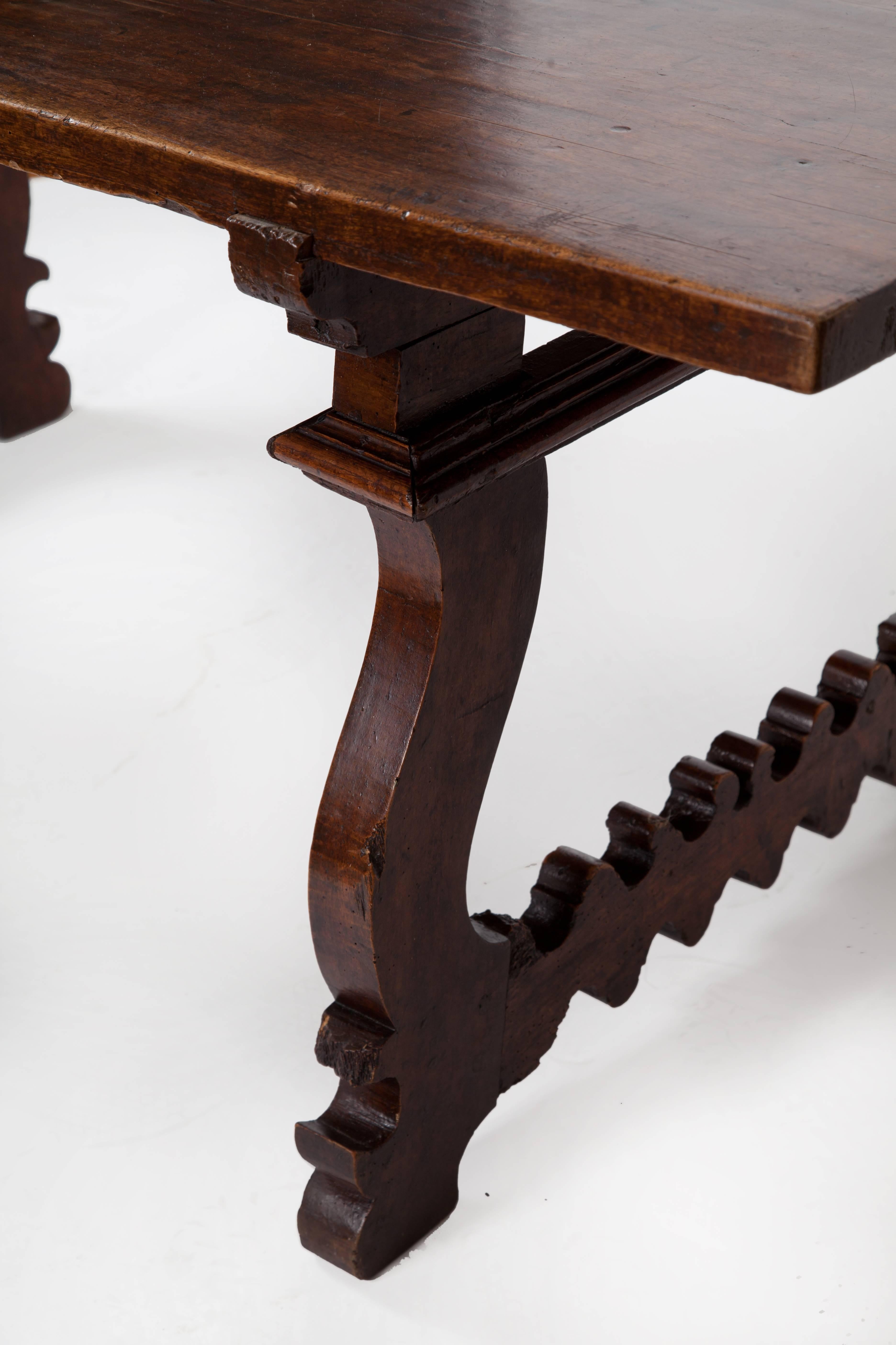 Beautiful 18th century dark Italian walnut table with lyre legs. Great patina. The top has several nicely placed mends.