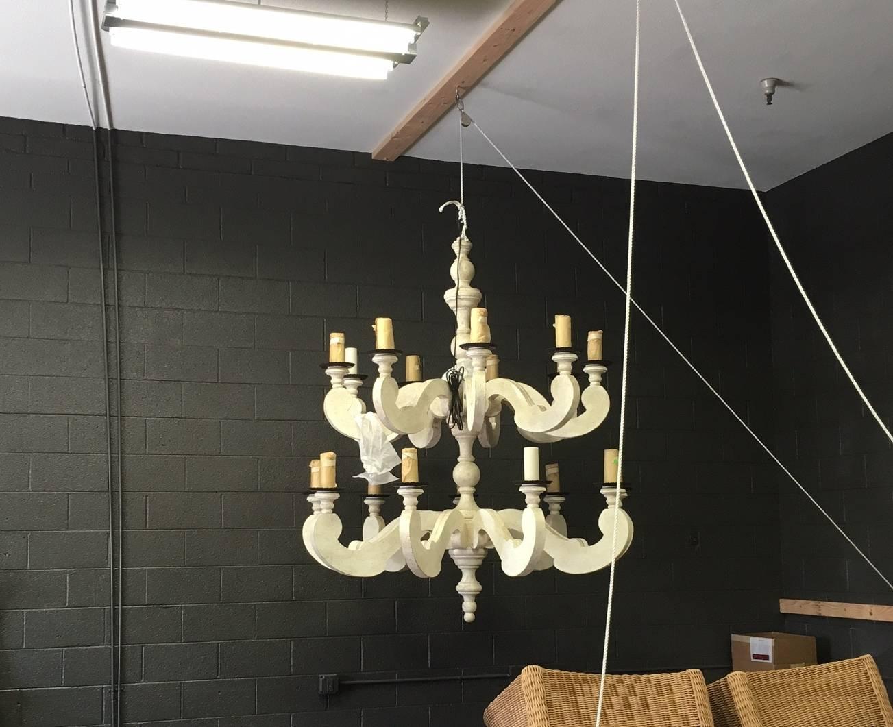 A pair of brand new Paul Ferrante two-tier country chandeliers in grande scale. Custom sized - 74" H x 65" Dia. White plaster gesso finish with iron bobeches and canopy and 8' of additional chain. Wax candles. Nine arms each tier. It uses