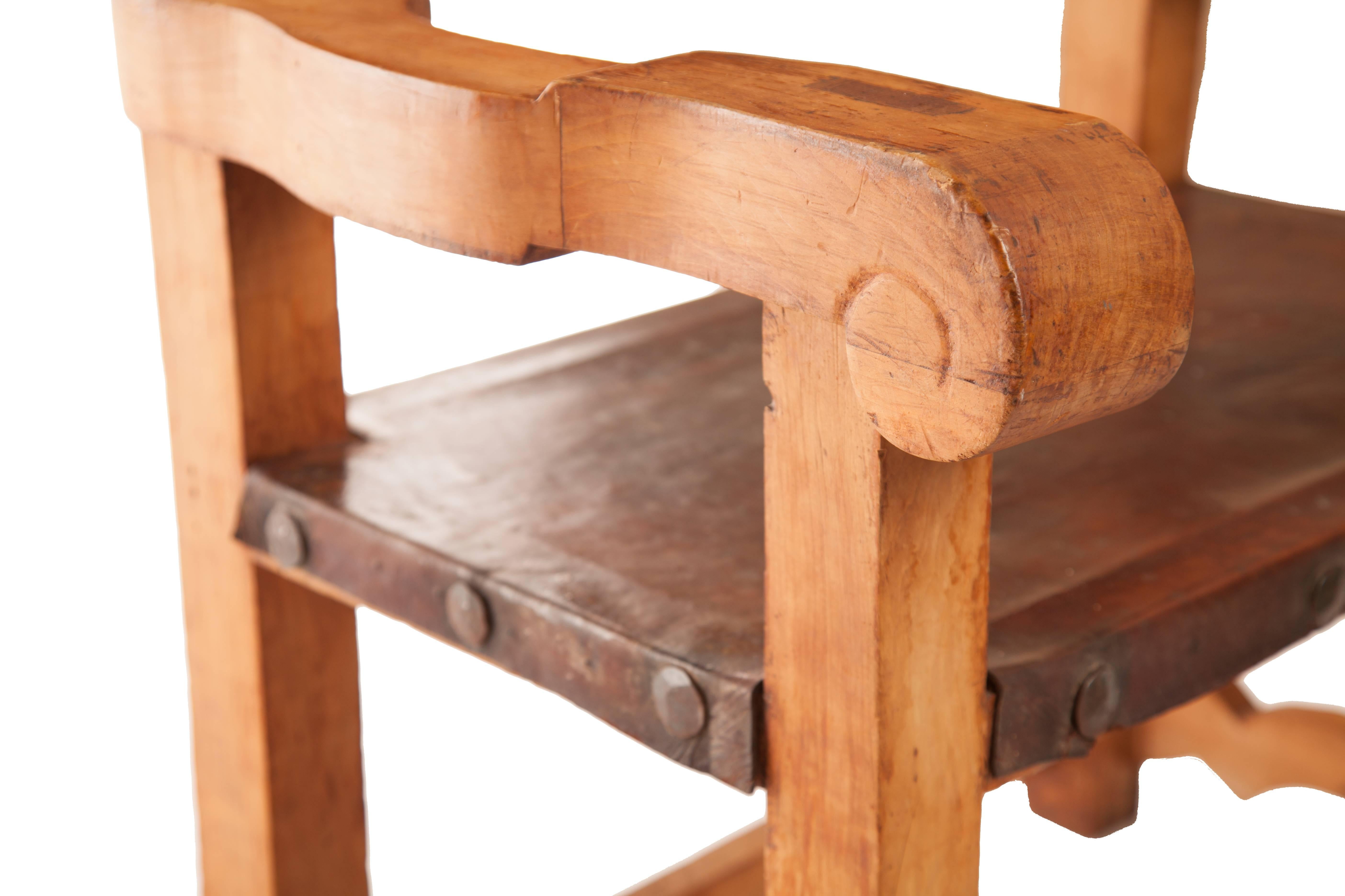 This lovely Frailero chair is from the estate of the renowned Mexican designer Hector Aguilar, circa 1940, made of Sabino pine wood and leather, there is a lovely copper repousse piece set into the inside back.