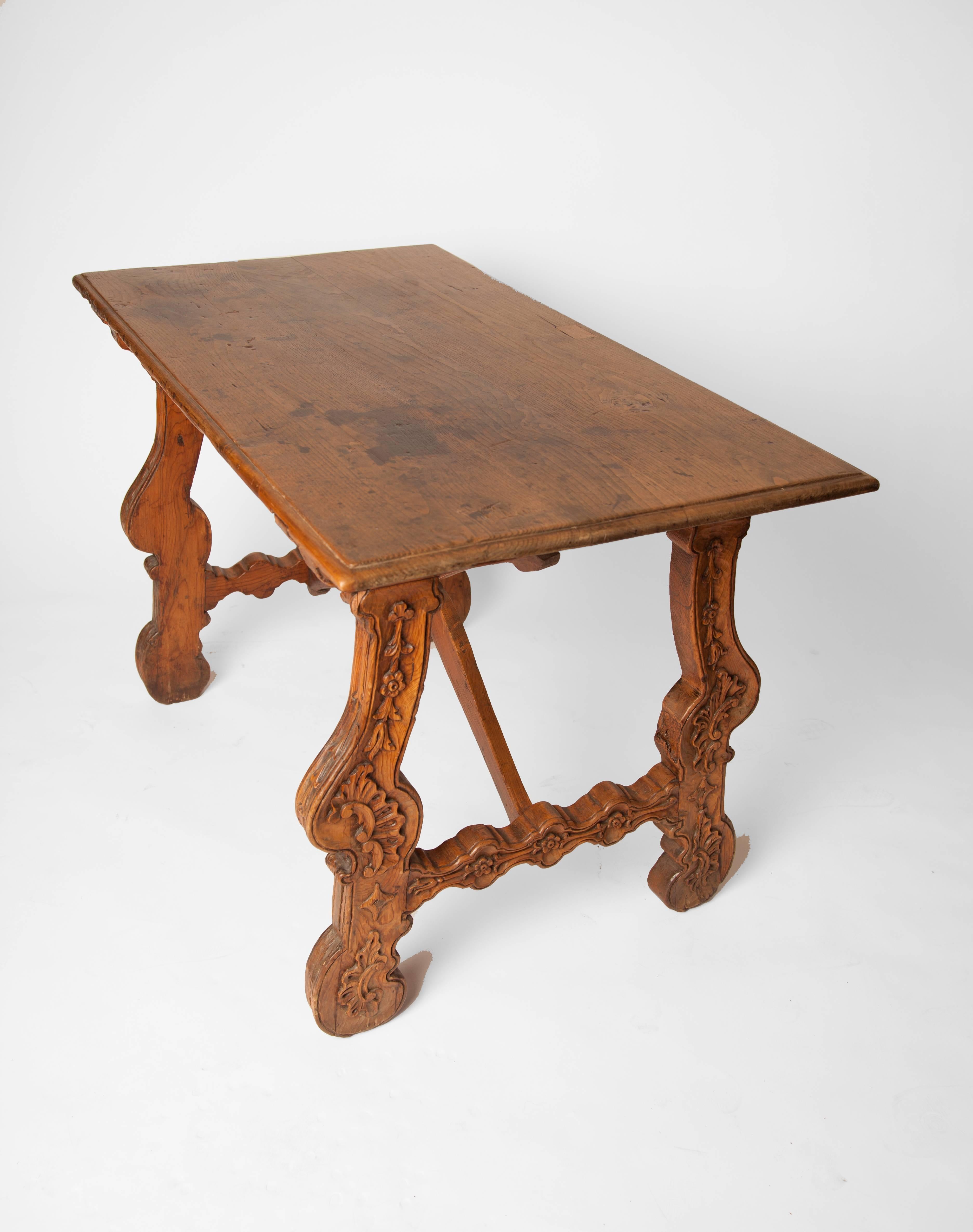 19th century Spanish walnut table with carved floral detailed legs.