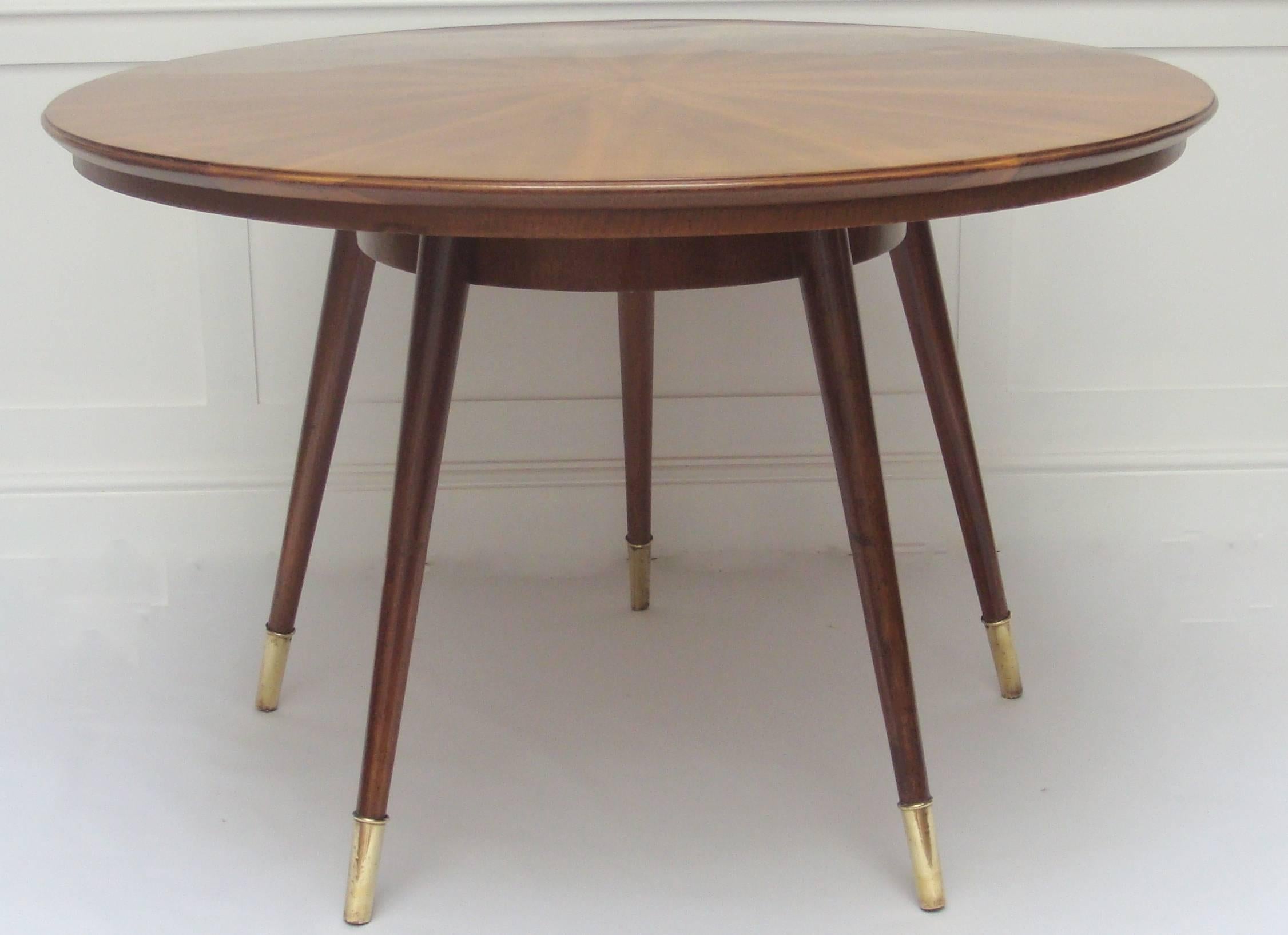 A circular starburst marquetry dining or centre table with five brass tipped legs attributed to Carlo De Carli.

Provenance: Private collection, Rome.
    