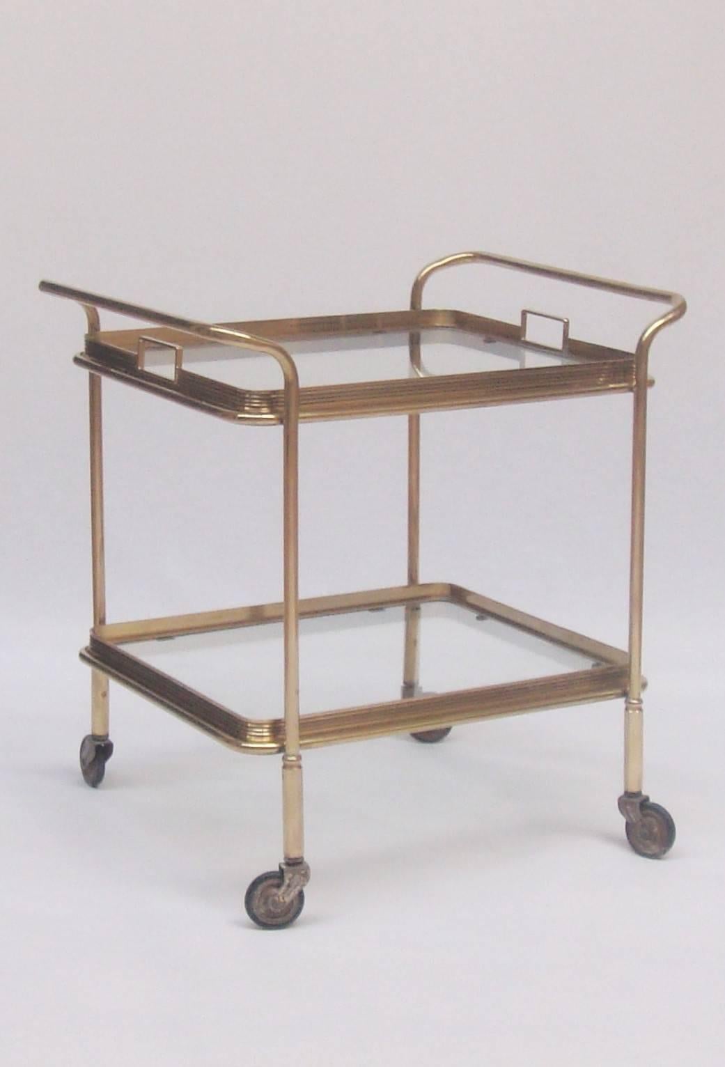 Small brass trolley with two ridged removable glass trays.
   