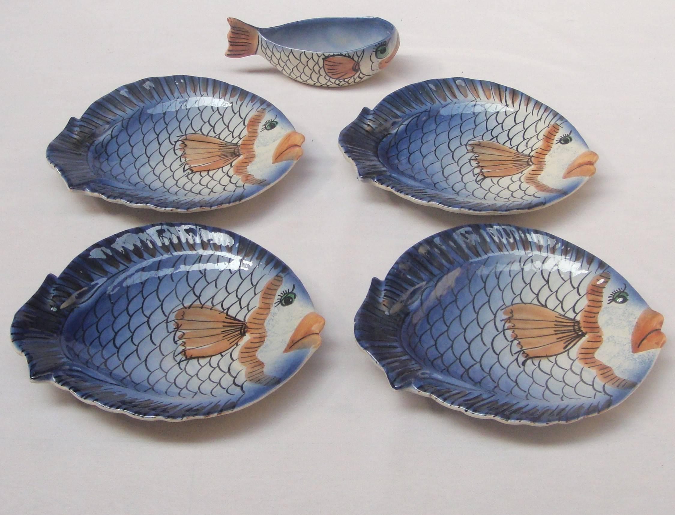 A set of four handmade and hand-painted ceramic plates
in the shape of fishes with matching jug.
Jug signed Vallauris on the base.
 