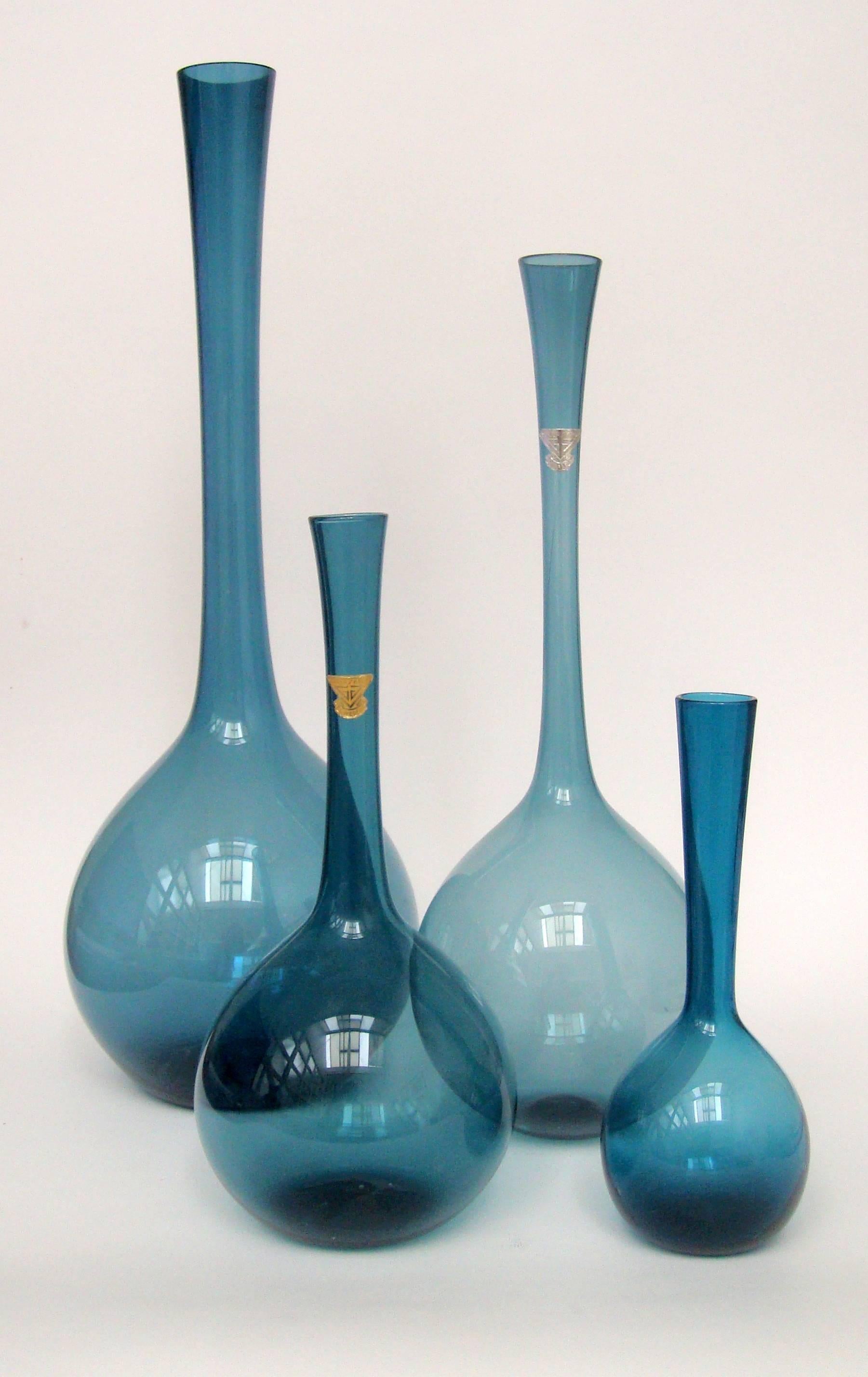 A collection of teal Blomglas bulb vases
designed by Arthur Percy for Gullaskruf.

Can be sold individually
Height: 6 ¾ in / 17 cm.
Height: 9 in / 23 cm.
Height: 12 ¾ in / 32.5 cm.
Height: 15 ¾ in / 40 cm.
      