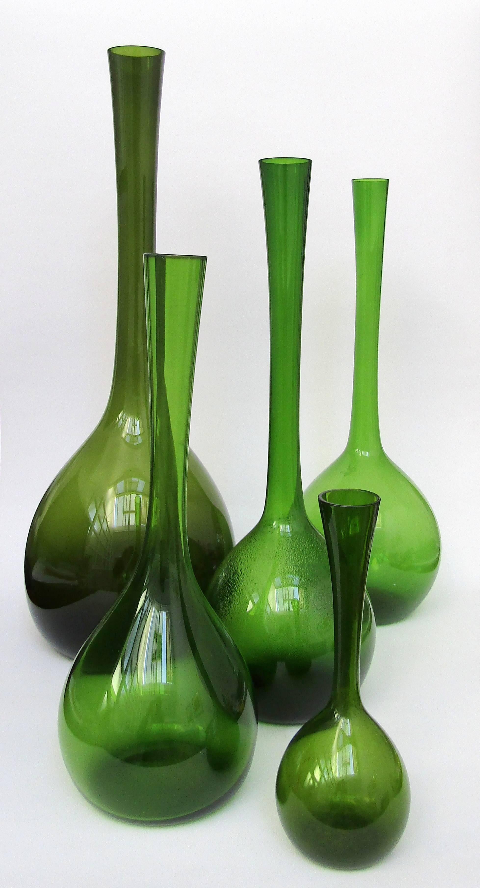 A collection of green blomglas bulb vases,
designed by Arthur Percy for Gullaskruf.

Sold individually:
Height: 8 in / 20 cm SOLD.
Height: 13 ¼ in / 33.5 cm £260.
Height: 15 ¾ in / 40 cm £360.
Height: 19 ¼ in / 49.5 cm £600.
  