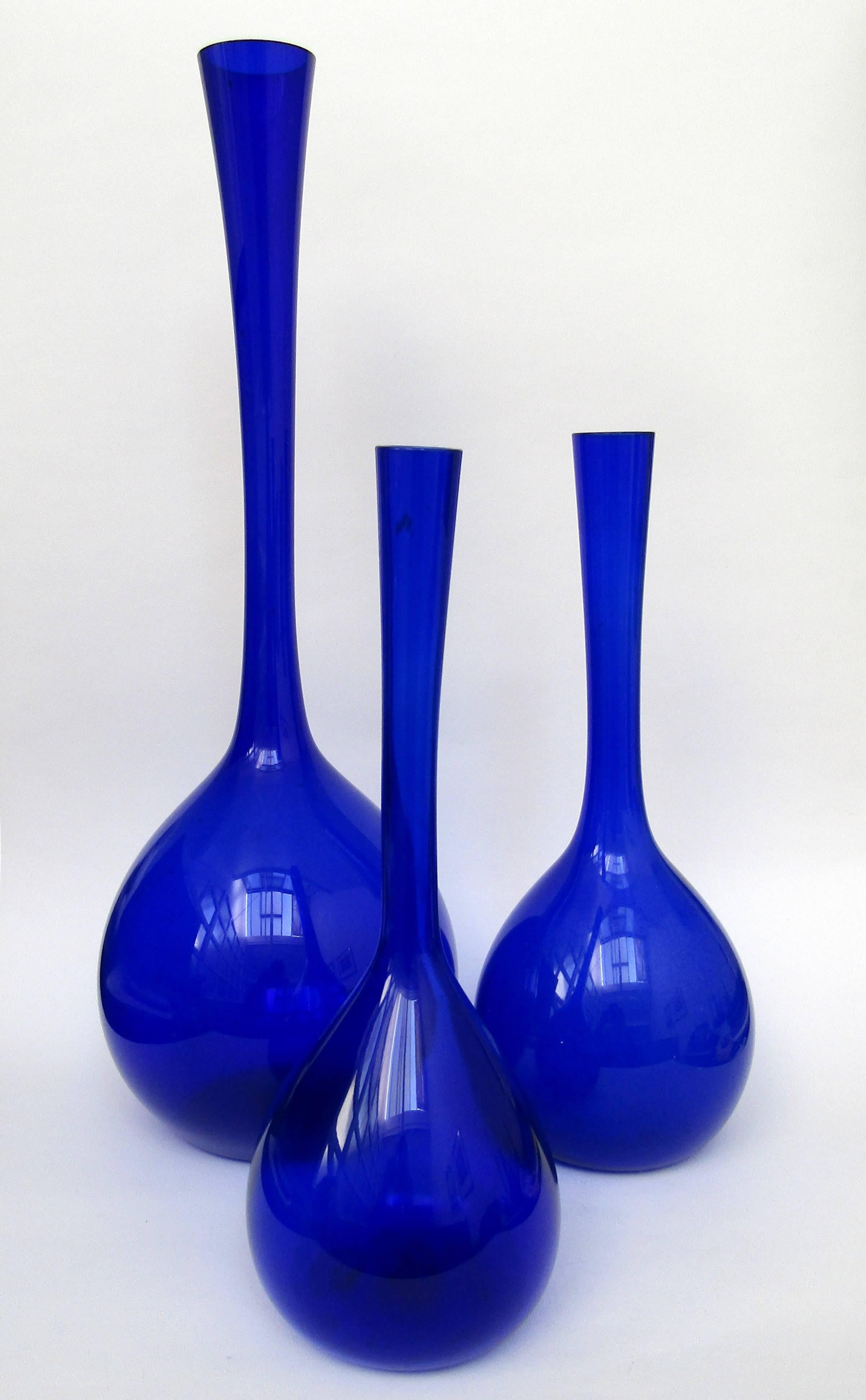 A collection of cobalt blomglas bulb vases,
designed by Arthur Percy for Gullaskruf.

Sold individually.
Height: 13 in / 33 cm £260.
 Height: 13 ¼ in / 33.5 cm £260.
 Height: 19 ¾ in / 50 cm SOLD
  