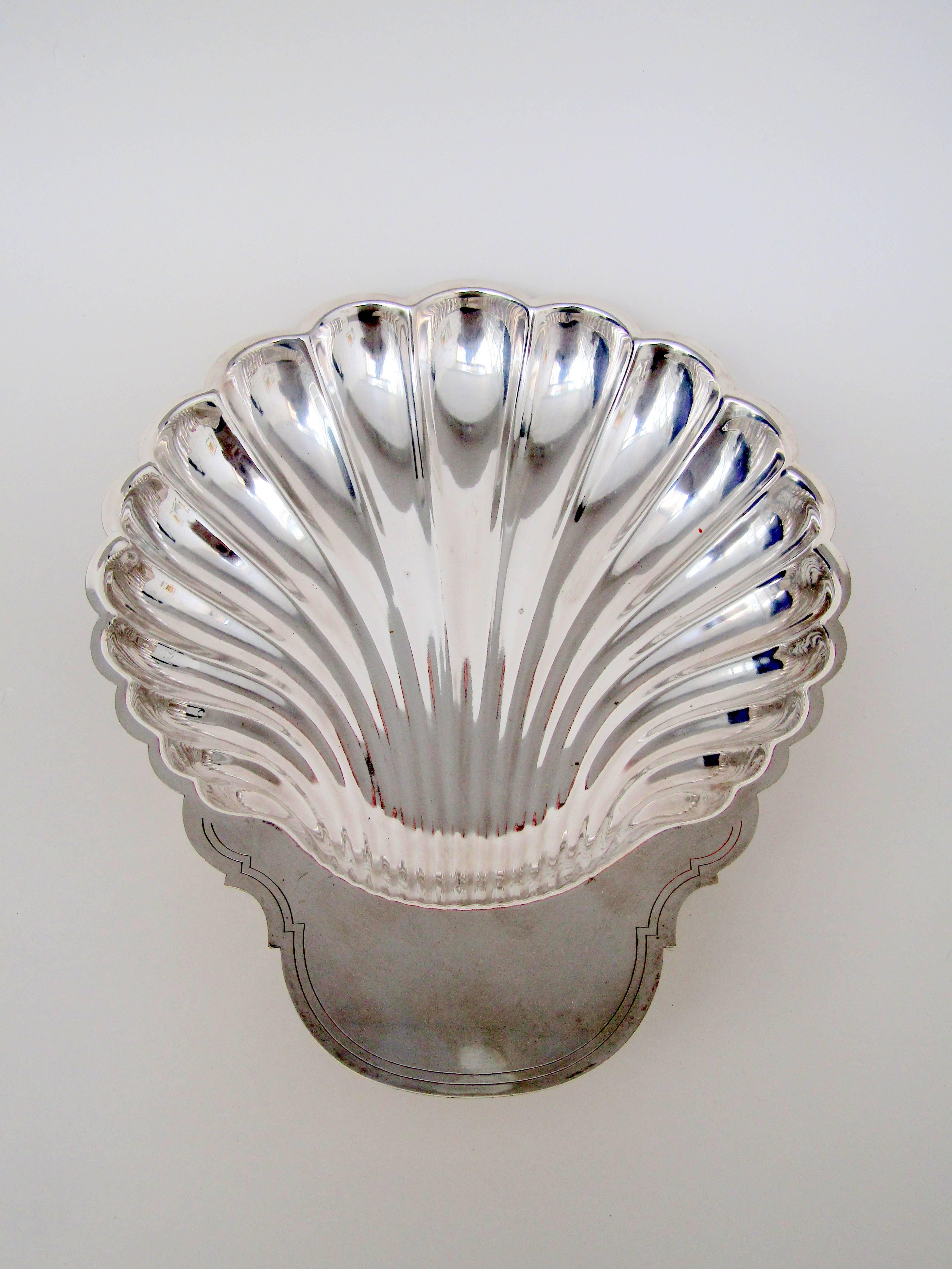 A large sliver plate dish in the shape of a scallop shell by Fleuron
Stamped Fleuron France.
 