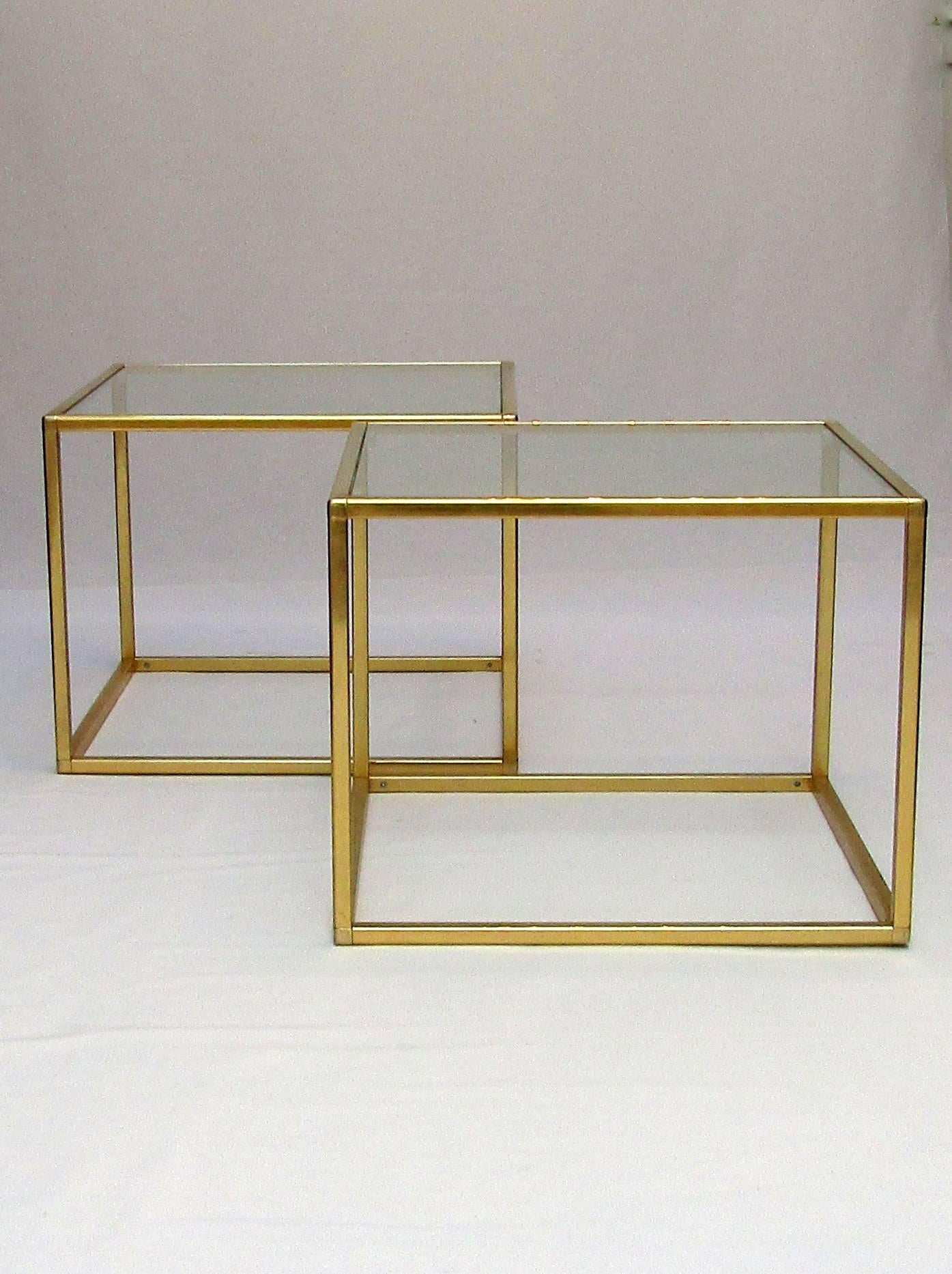 A pair of brass and glass cube end tables.