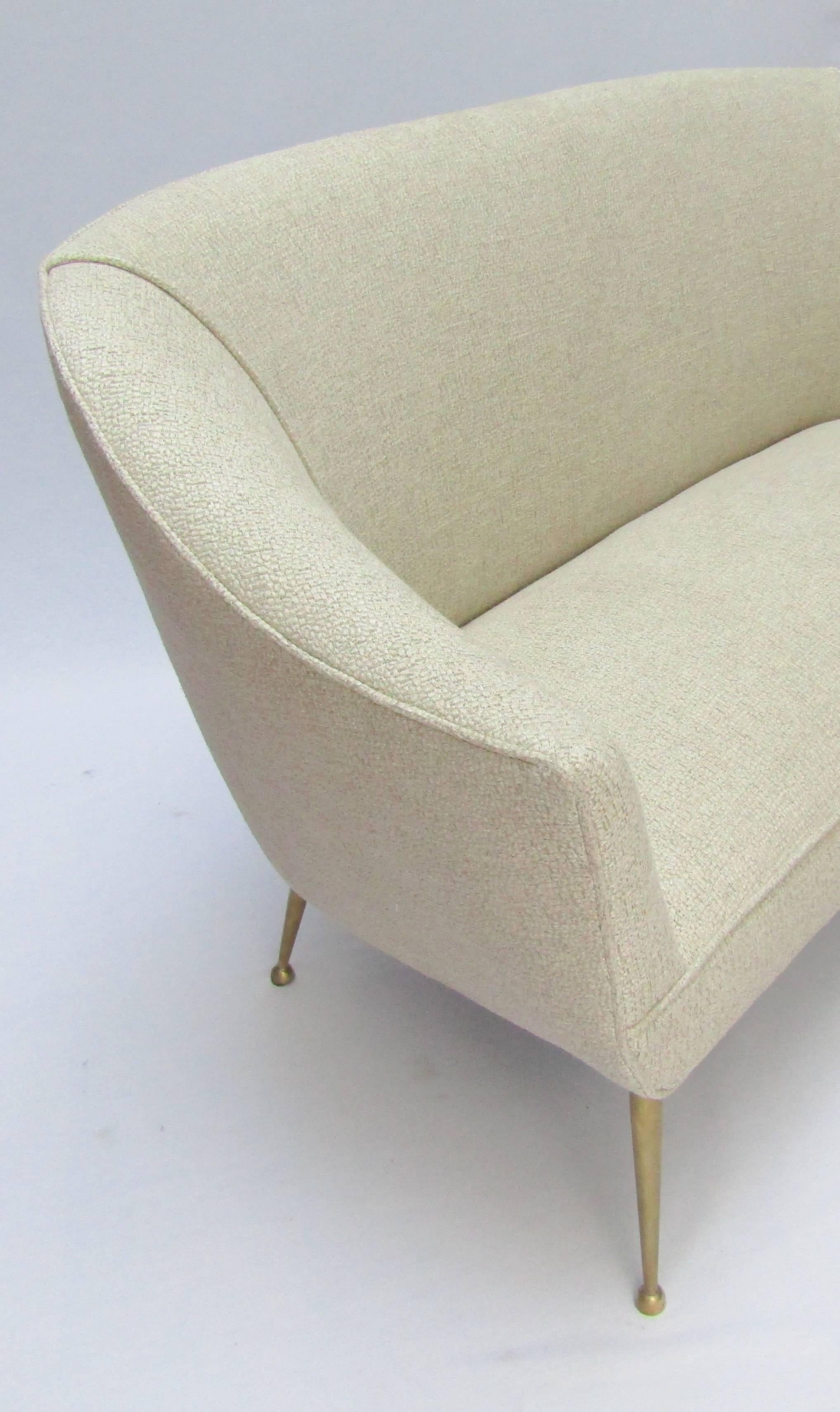 A two-seat sofa with brass legs
upholstered in Osborne & Little Antibes fabric (color 06)
(cushions sold separately)
