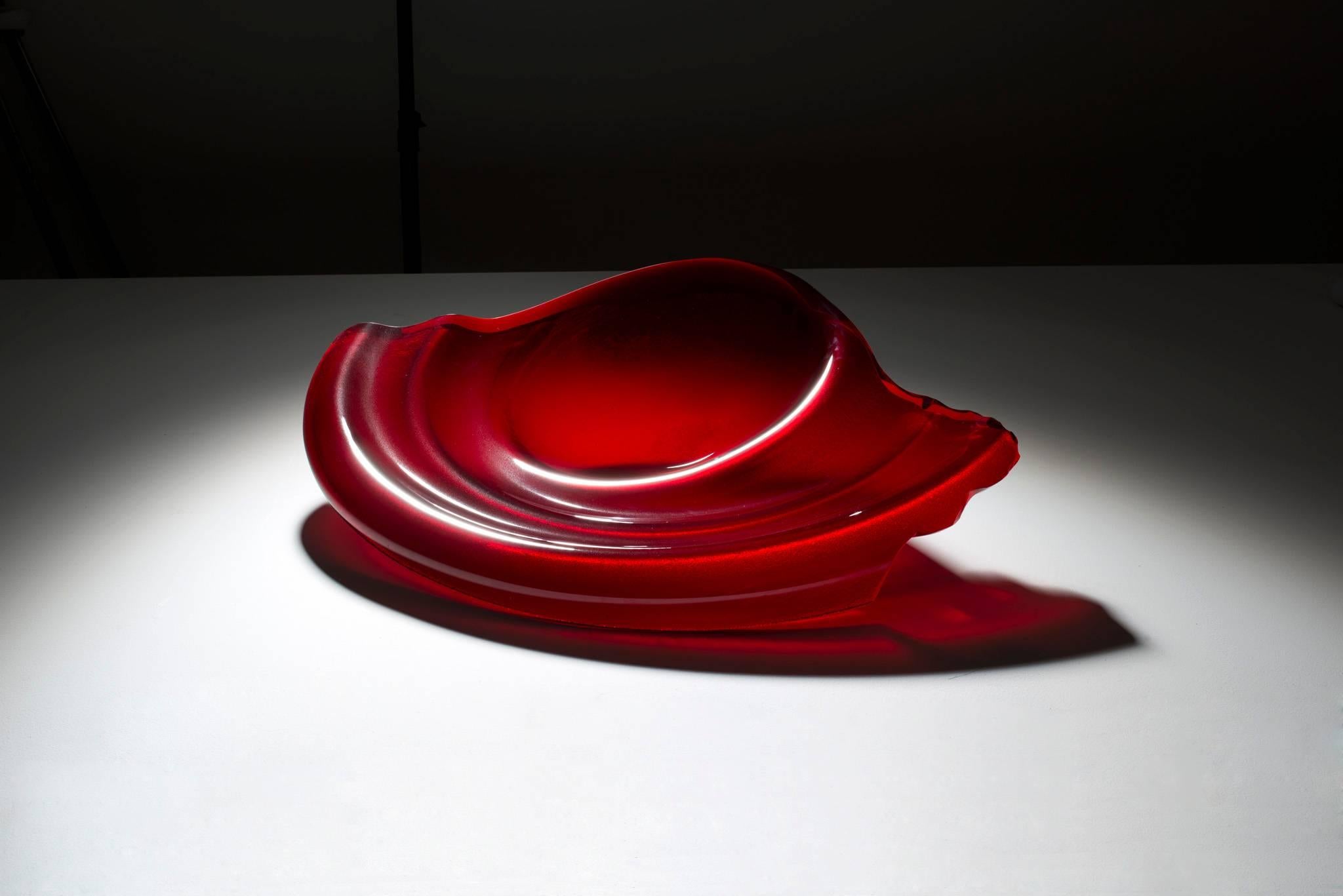 Danny Lane Studio poured glass bowl sculpture. Exquisite dark red studio poured glass with heat formed undulations and hammer fractured and polished edge.