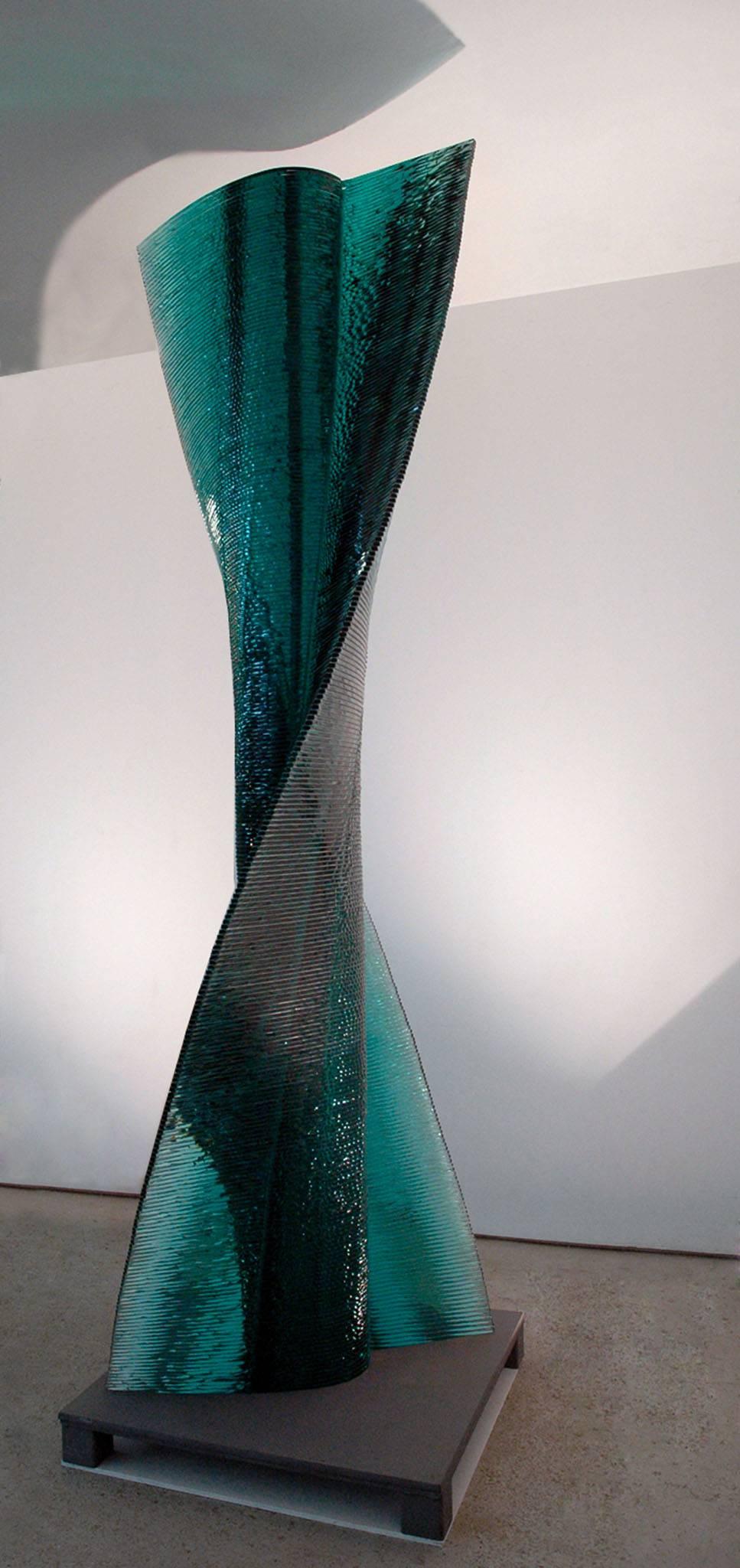 Six is nine, unique glass sculpture by Danny Lane.

The sculpture is of 254 layers of float glass intricately cut float glass. The form spirals from it's solid core to tapered wings on opposing sides. The centre is a deep emerald green that