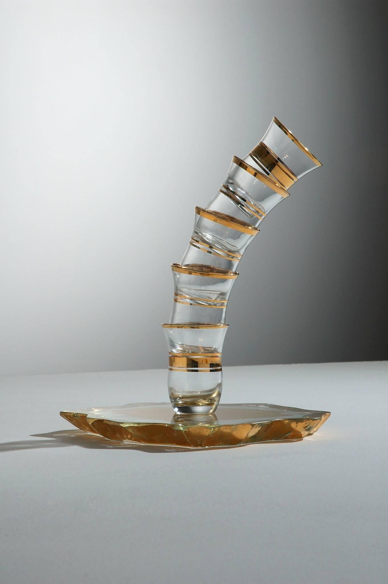 Whimsical functional sculpture made from gold leaf on 19mm thick carved float glass and Turkish tea glasses.