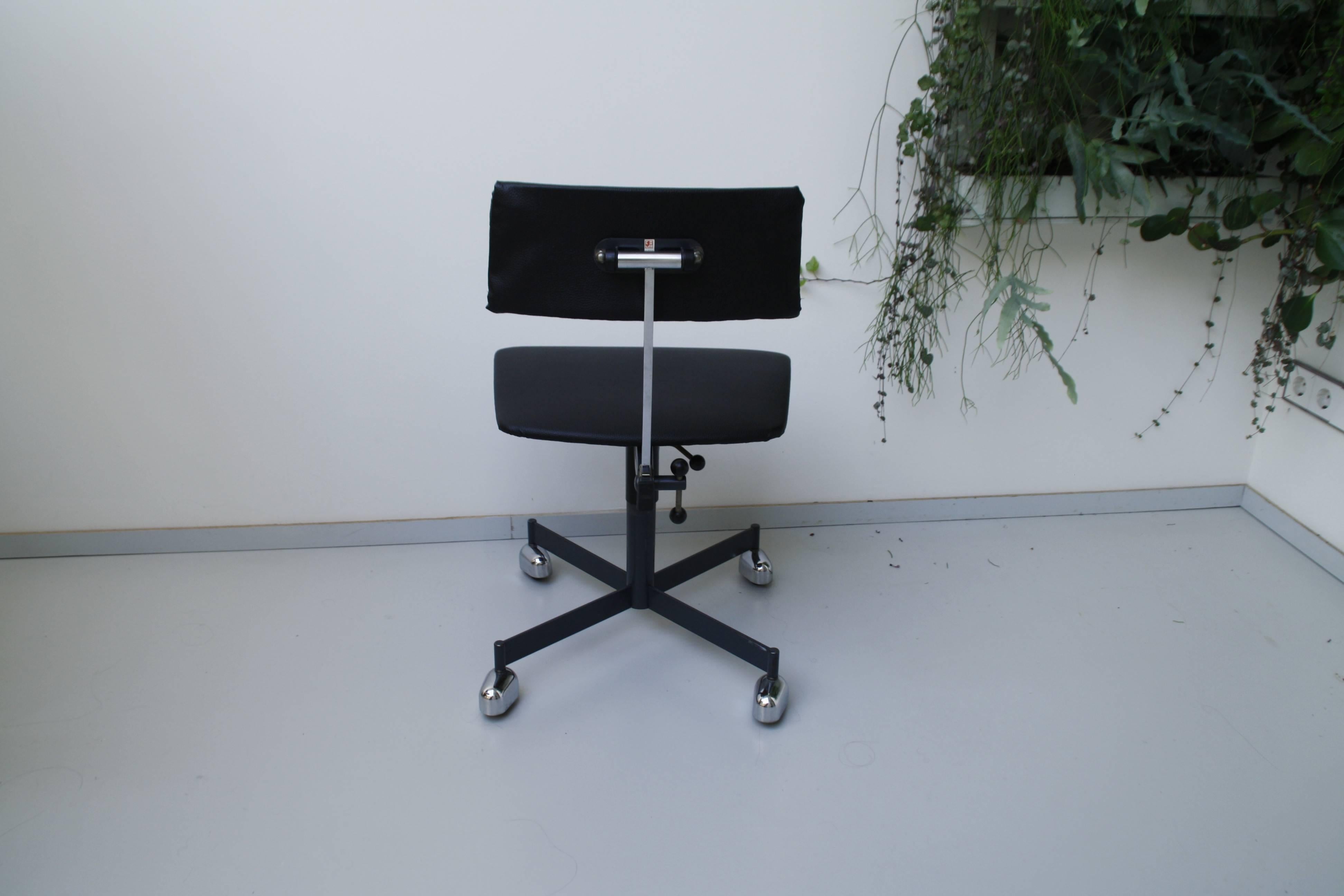An early model of the adjustable Kevi swivel chair of the designers Ib & Jørgen Rasmussen. The seat and back are black leatherette, the base is black steel and the casters are the rare chrome covered design. 
Measures: Seat height 40-55 cm.
 