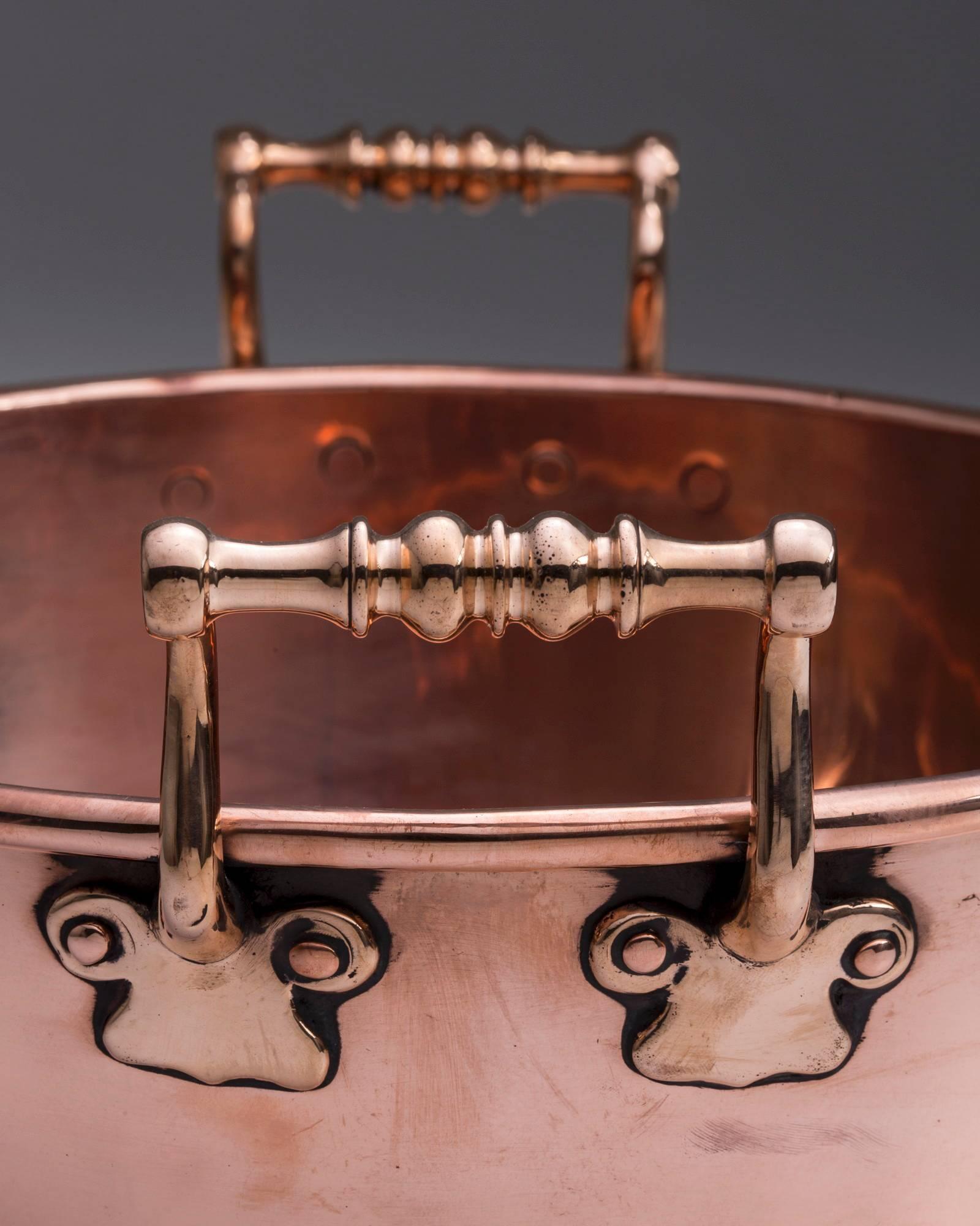 English, copper preserve pan. Unmarked.

Date: circa 1860.

12.625” diameter by 4.125” deep. The total width across the handles is 14.25”.

The handles on this preserve pan are much more ornate than the standard English shape. The piece is