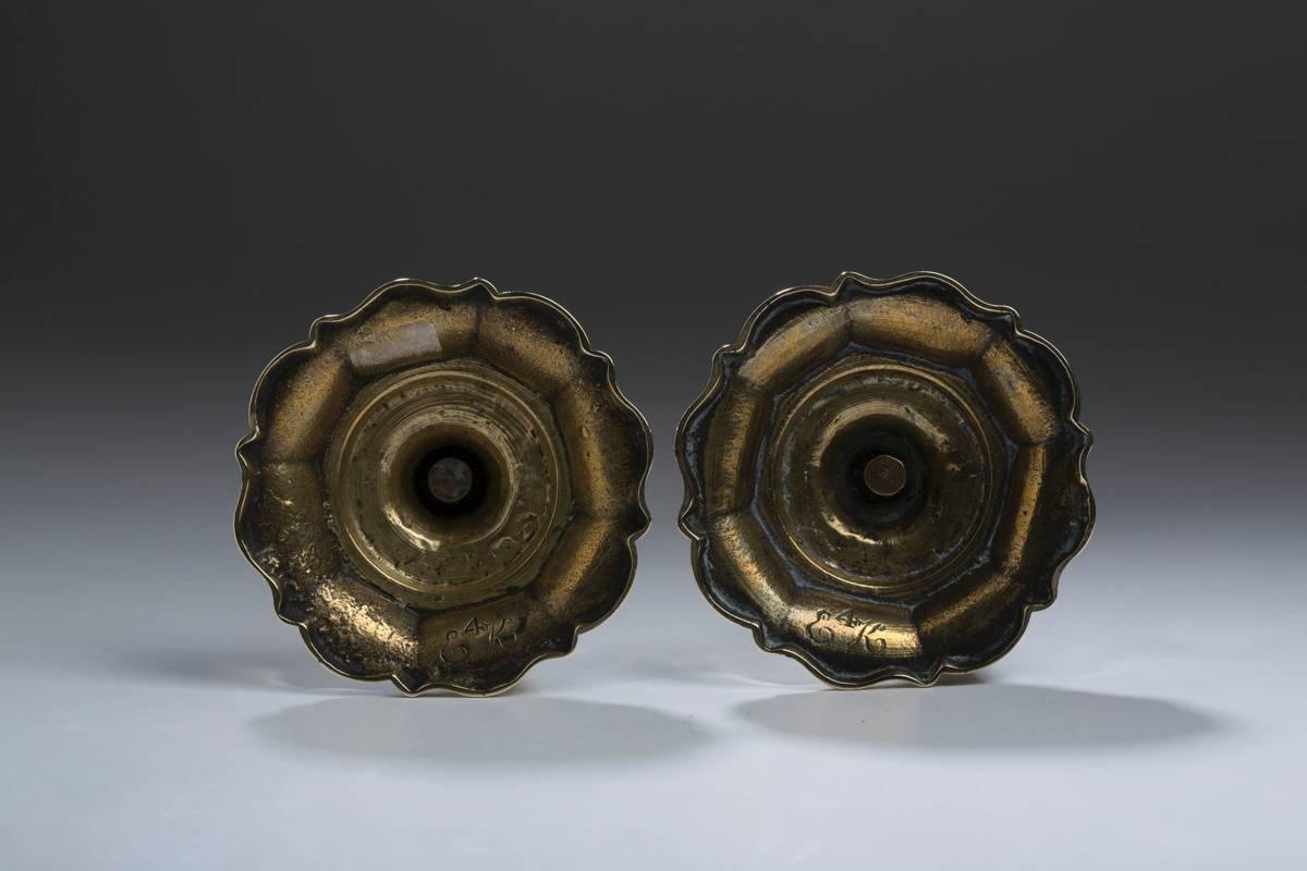 English, brass pair of seamed daisy base candlesticks with conforming bobeches, measures 8.25″ H, 4.375″ base, circa 1770.
