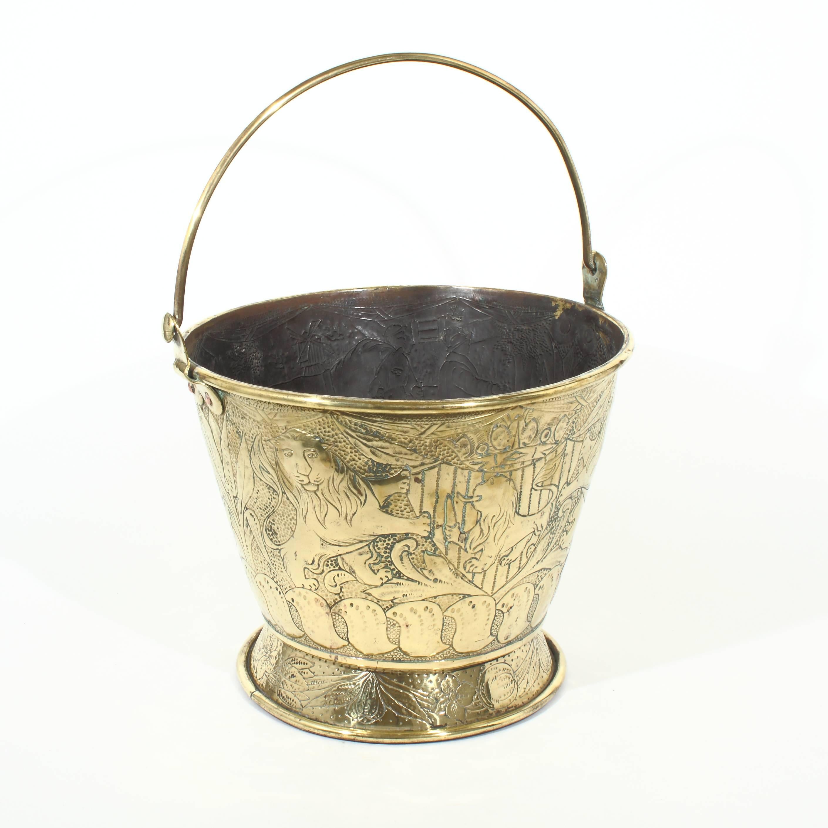 Dutch, embossed brass bucket with swing handle.

Horse and man on one side and two lions on the other, circa 1890.
Height to rim 10.75