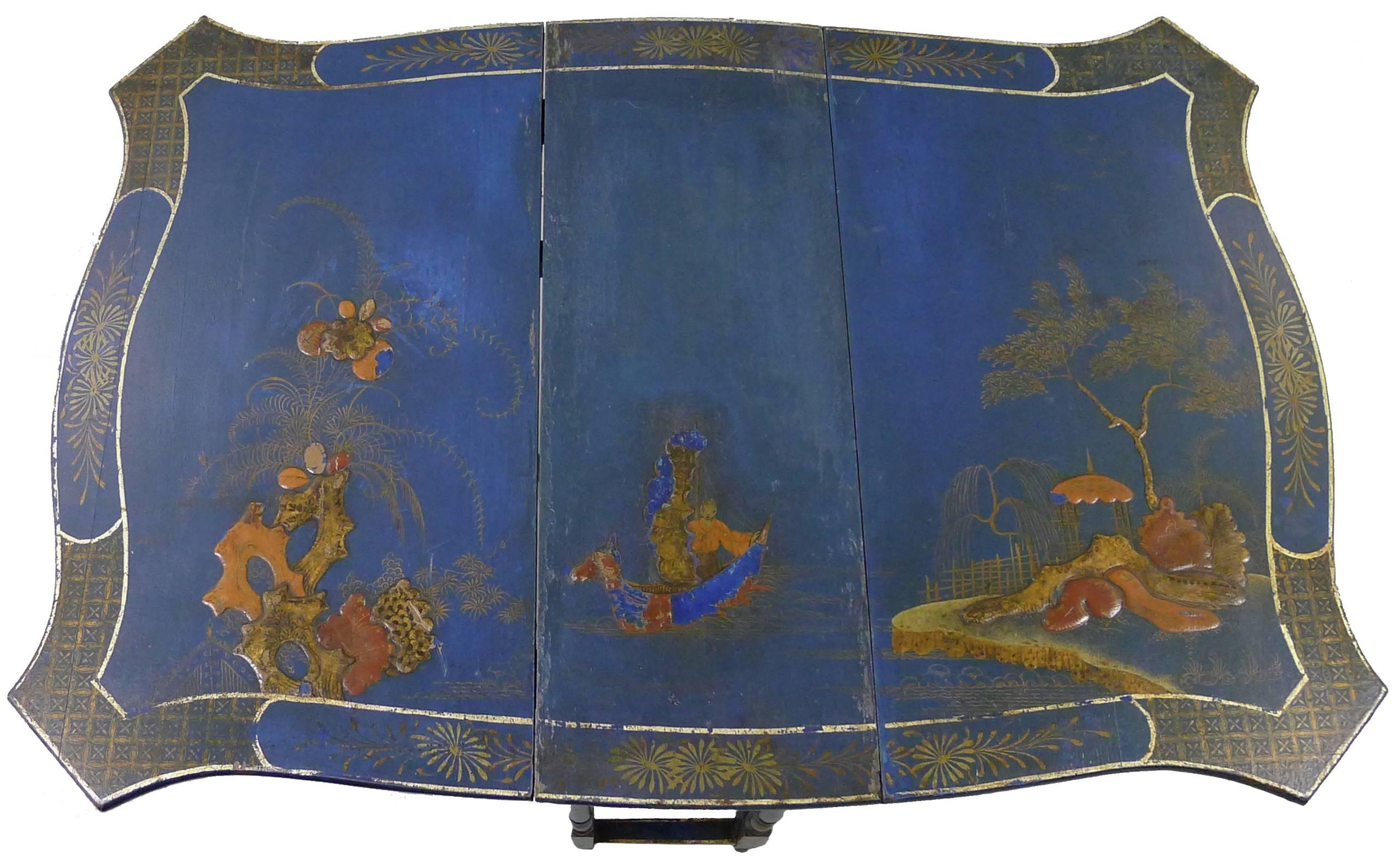 Chinese Export style tea table. Hand detailed japanned finish in unusual deep medium blue with polychrome overlay. Chinoiserie bell detailing. Double gate-leg drop leaf style. 17