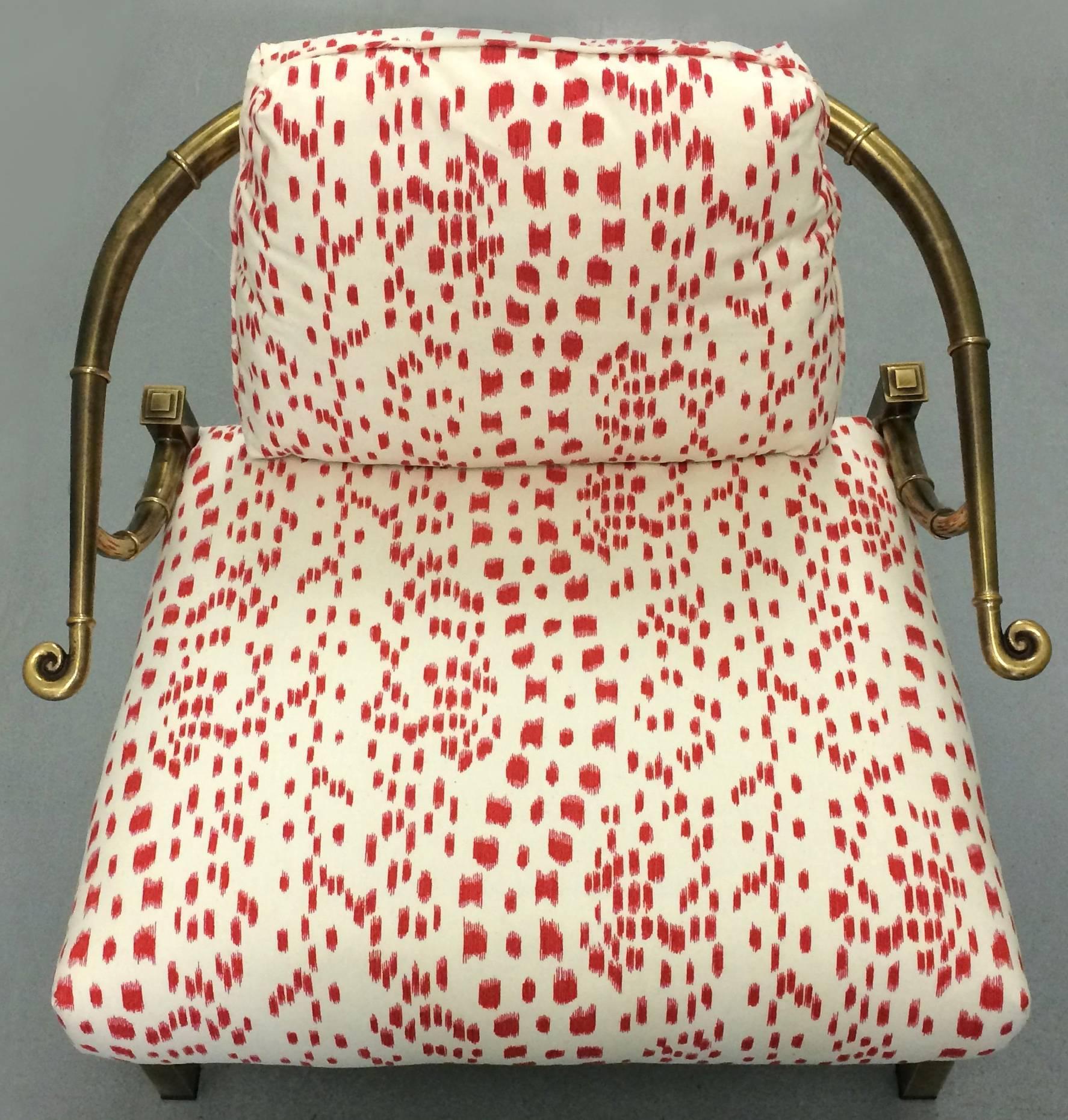 1970s chinoiserie brass horseshoe chair by Mastercraft. Burnished brass finish with bamboo detailing around the arms. Newly upholstered in Brunschwig et Fils Les Touches in red/cream. Removable back cushion. Seat 18" H. 

 