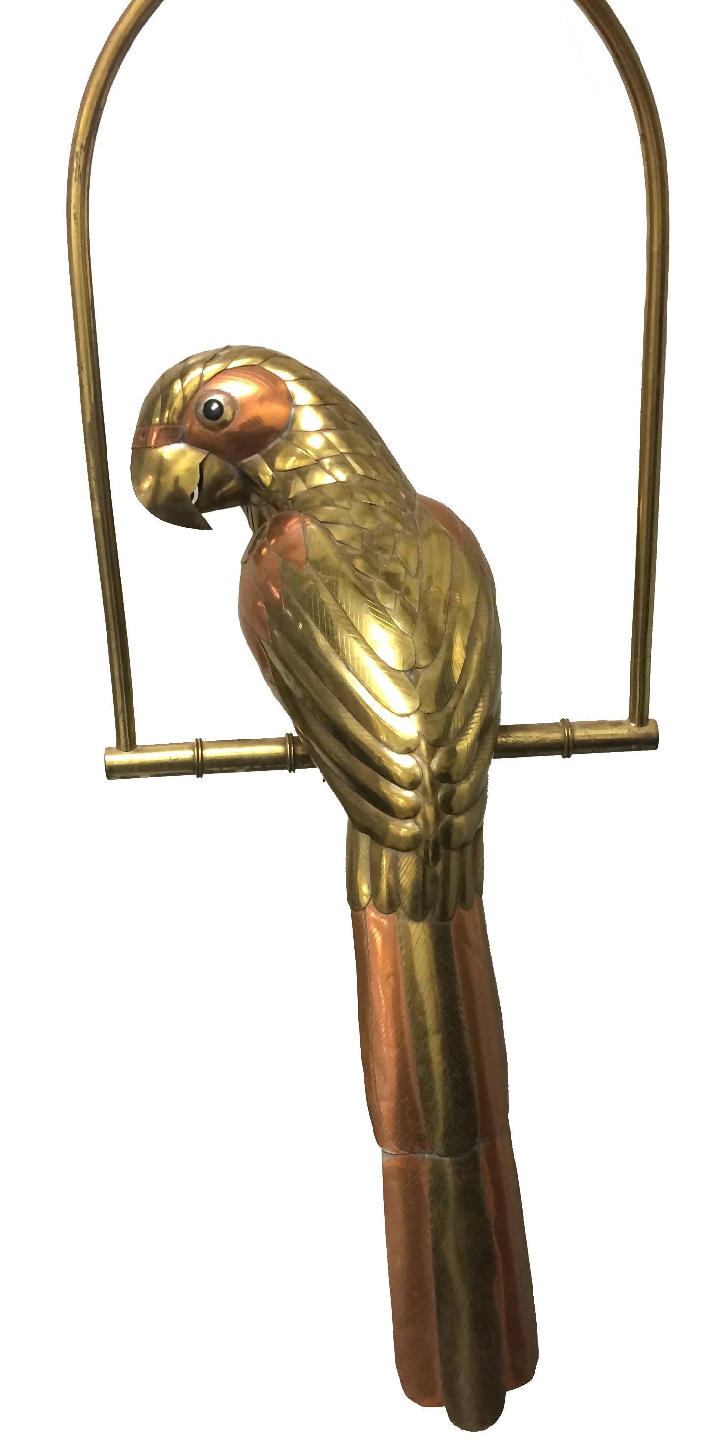 1970s hanging brass and copper metal parrot by Sergio Bustamante. Brass stand with bamboo style accents. Unsigned. Stand is 14