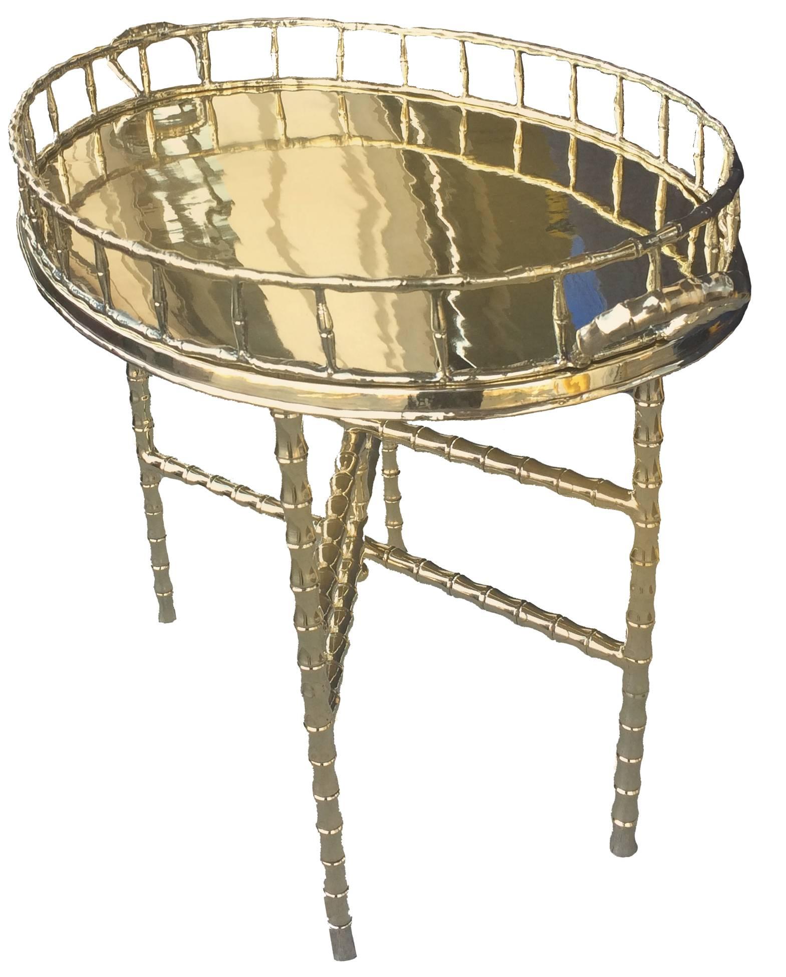 1960s brass bamboo-style table with oval tray top. Tray removes from stand and stand folds flat. Recently re-plated and polished.
 