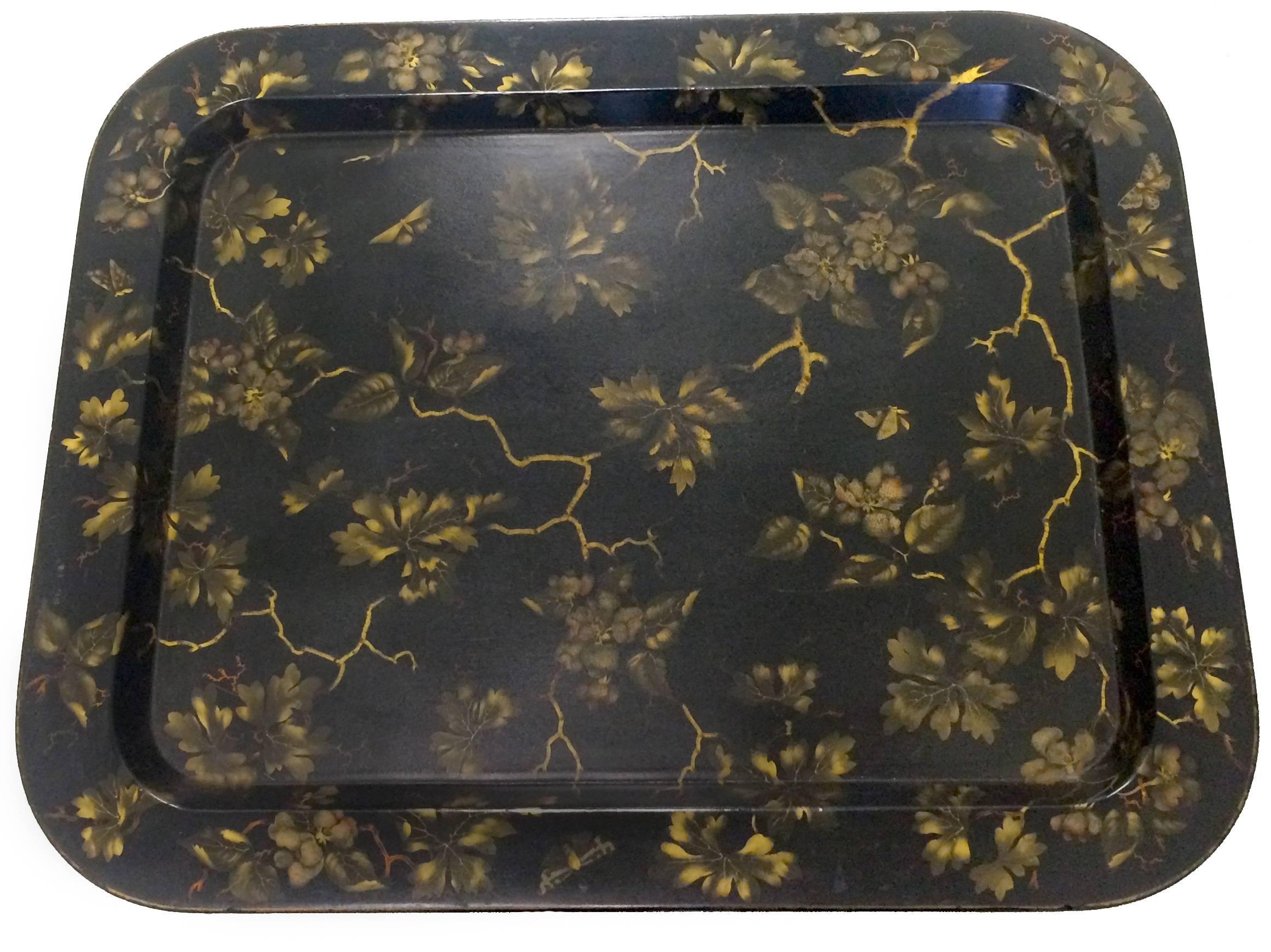 1930s English papier mâché tray table. Black and gold Chinoiserie hand-painted tray. Black bamboo style base with gold painted accents. Green felt table liner.