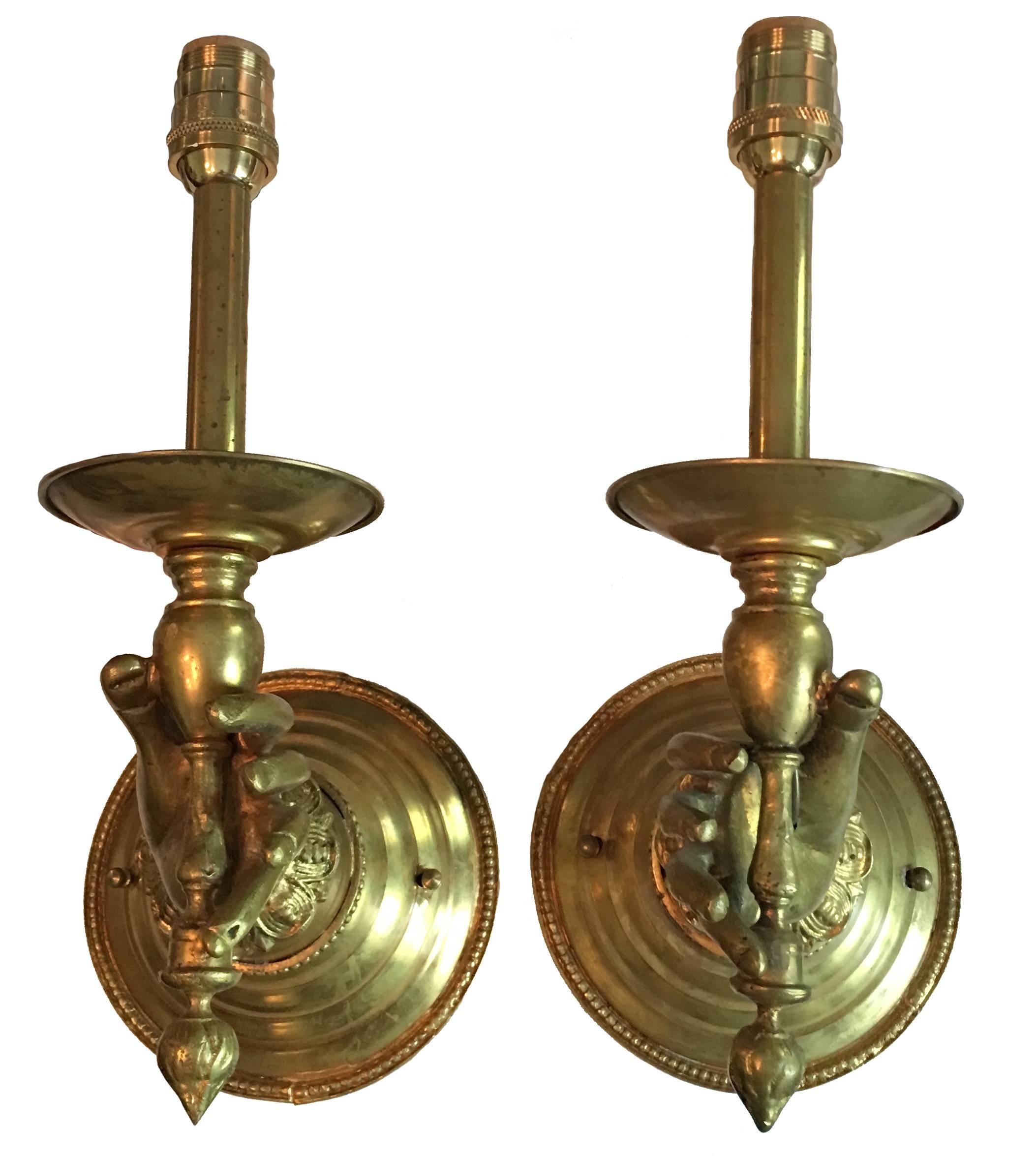 Pair of Victorian brass hand sconces, circa 1880s. Solid brass construction. Newly electrified and take one candelabra bulb each.