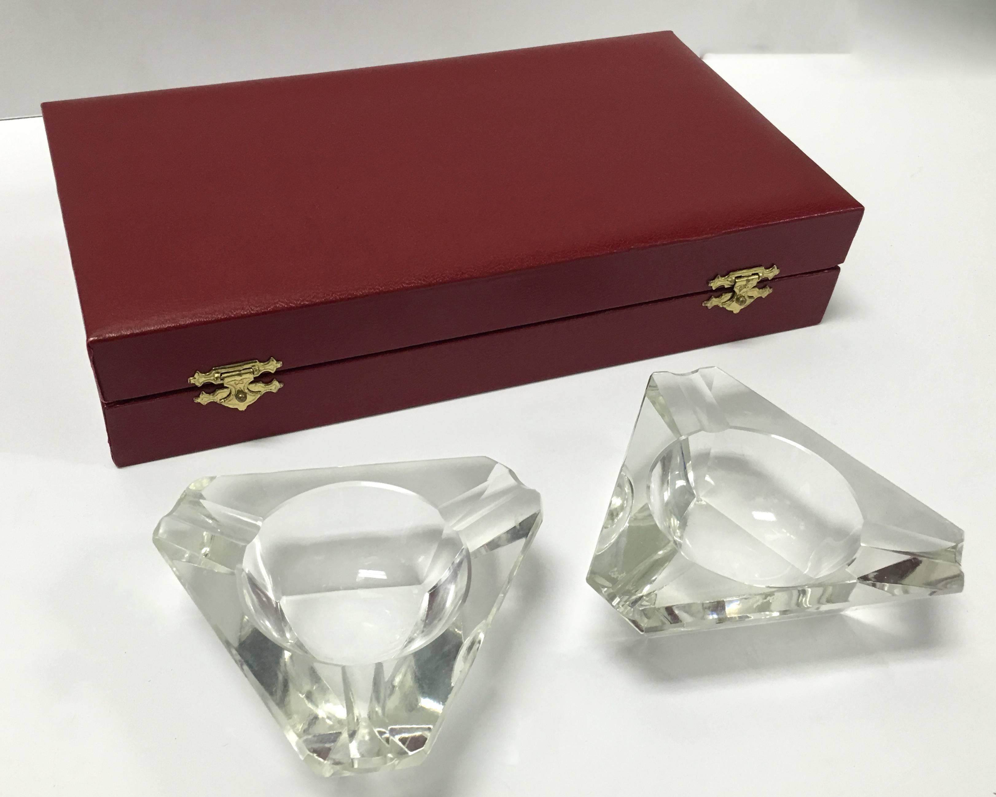 1980s pair of Cartier faceted crystal ashtrays. Original red leather Cartier box is included. Each ashtray is signed Cartier on the bottom.