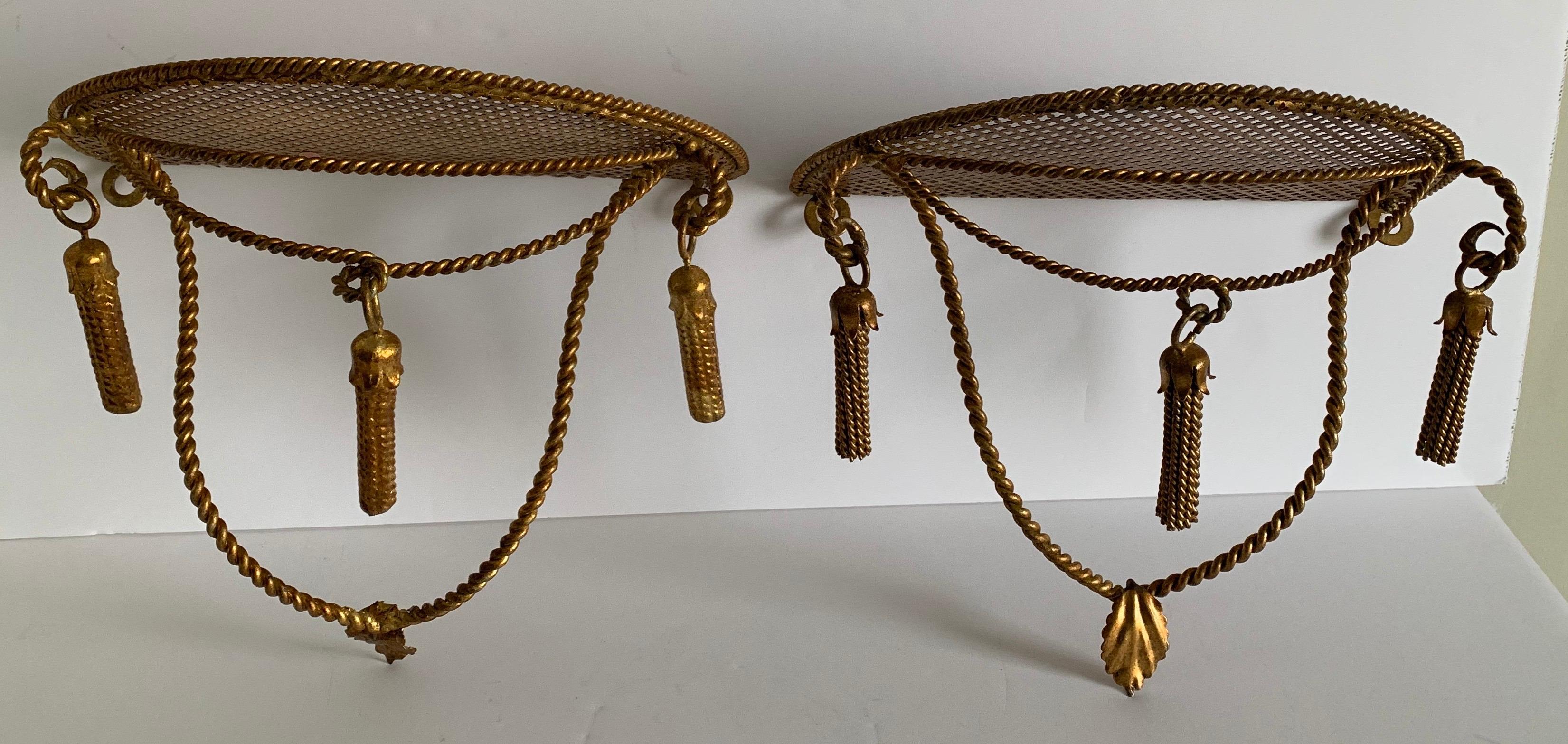 Pair of Italian gilt metal wall brackets. Original gilt metal finish with tassel detailing. One bracket retains 'Made in Italy' sticker on the underside. Hanging hardware is not included.