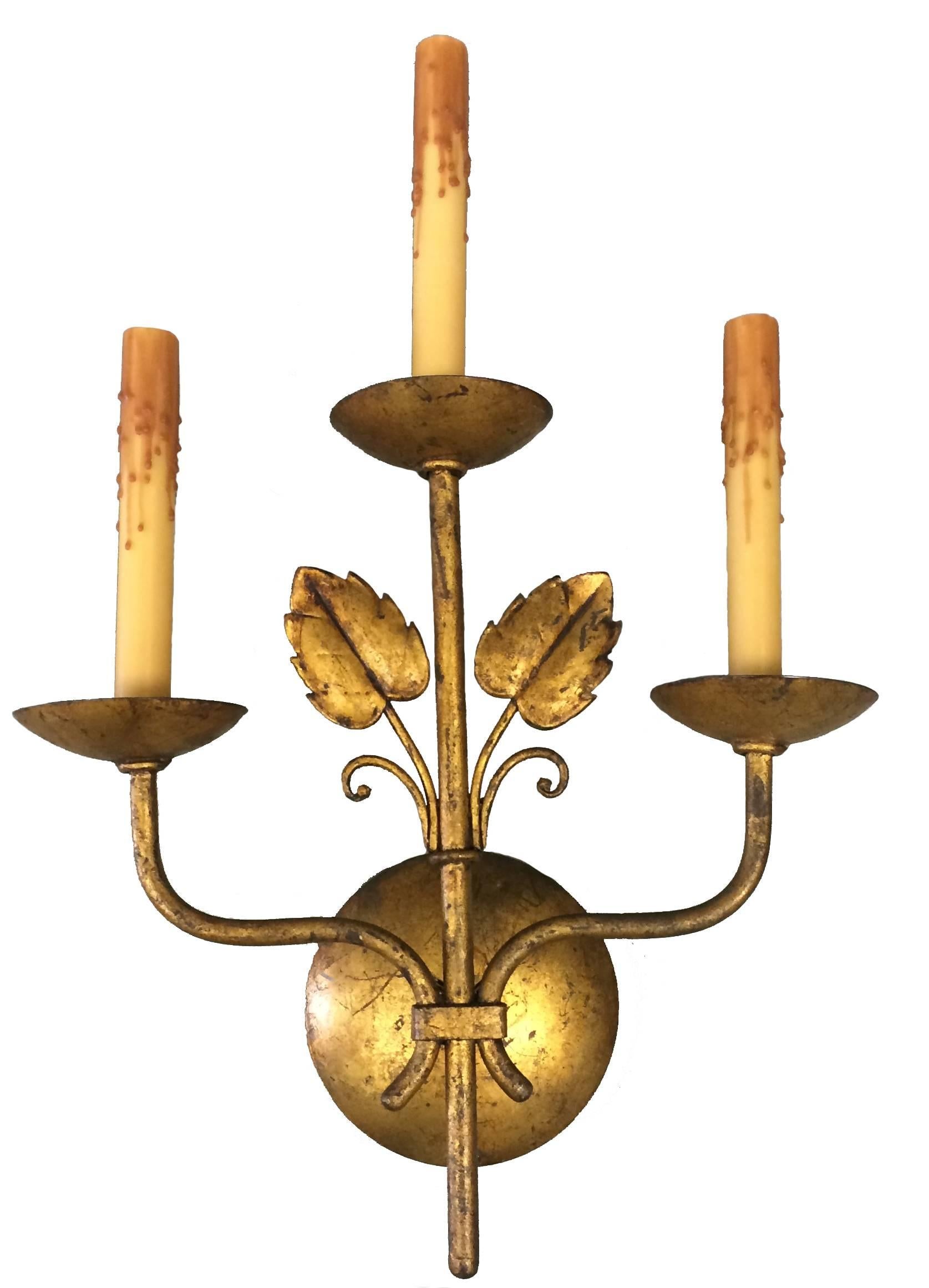 Pair of Mid-Century large French leaf sconces in gilt brass. Natural beeswax candle covers. Newly wired. Takes three chandelier bulbs each. Lampshades not included.