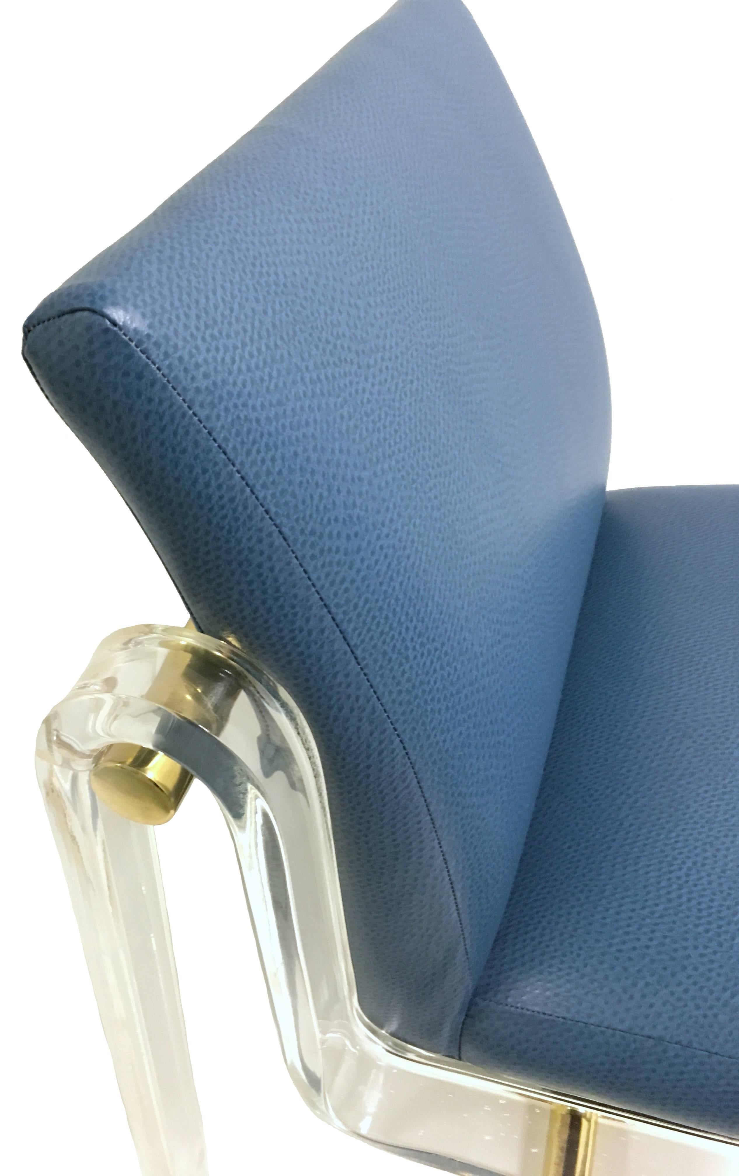1970s lucite and brass chair attributed to Pace. Newly upholstered in medium blue printed faux leather. Perfect as a desk, vanity or accent chair. Photo two best represents color and print of fabric.