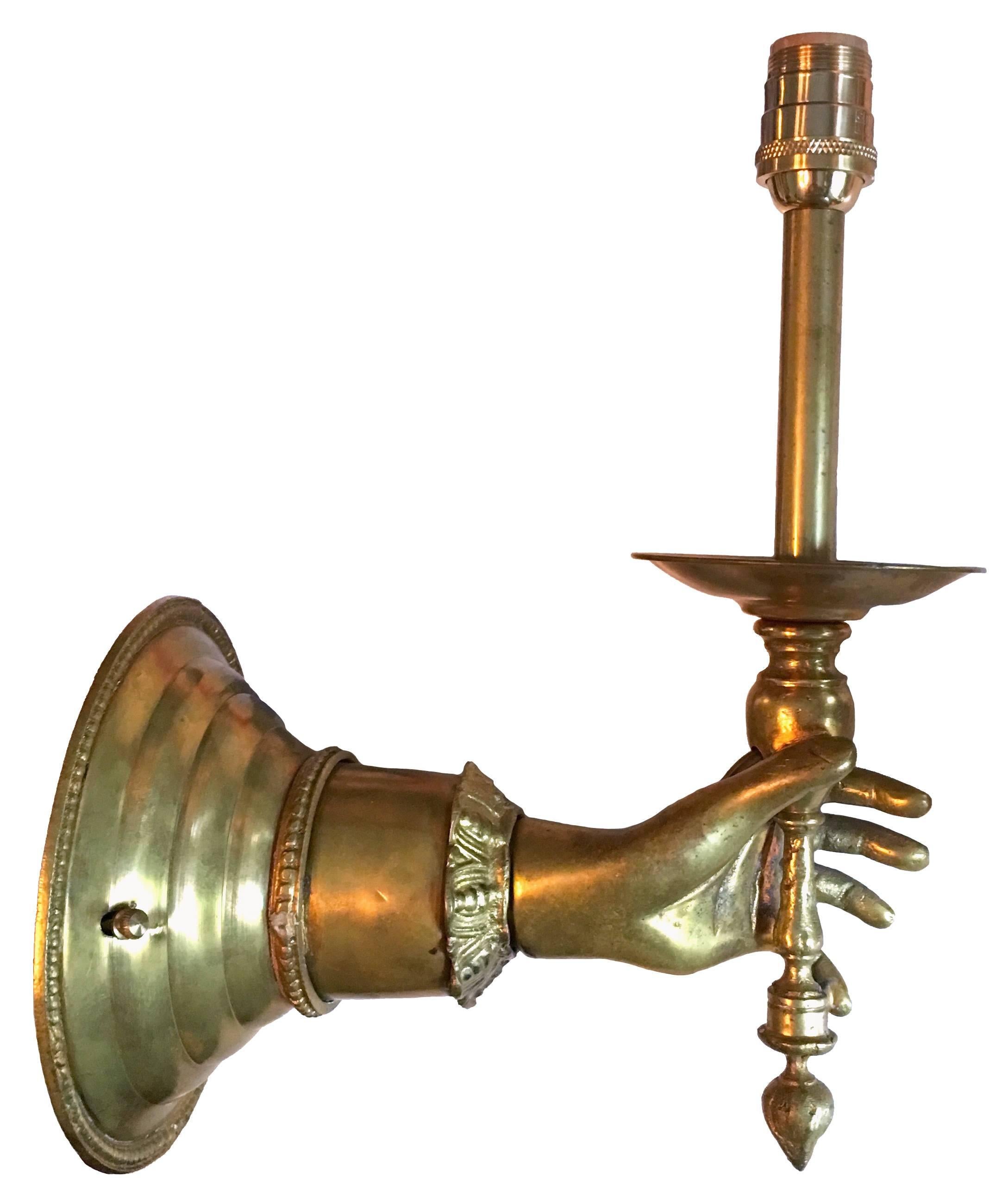 brass hand wall sconce