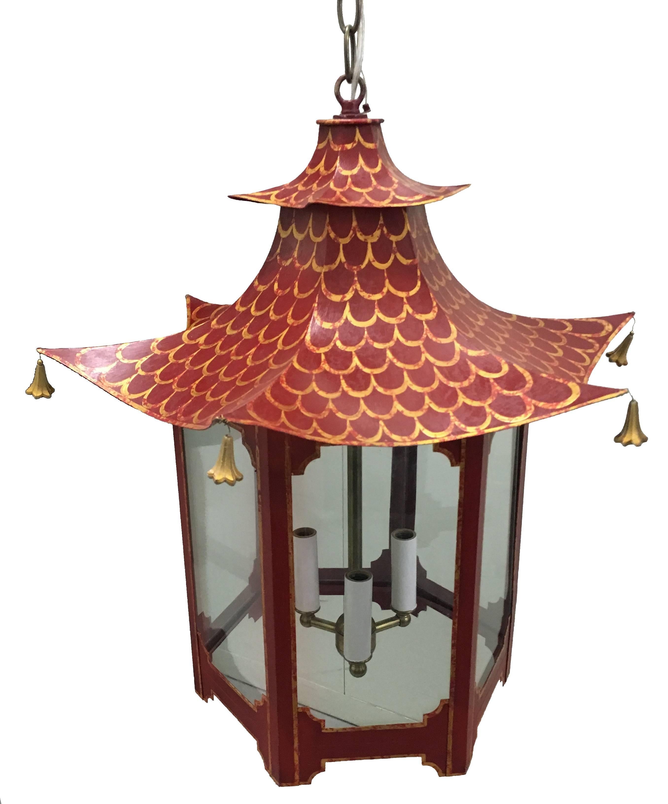 Custom chinoiserie pagoda chandelier. Hand-painted red finish with gold accents. Clear glass panels. Newly rewired. Takes three chandelier bulbs. Measures: 24" L chain and canopy included.