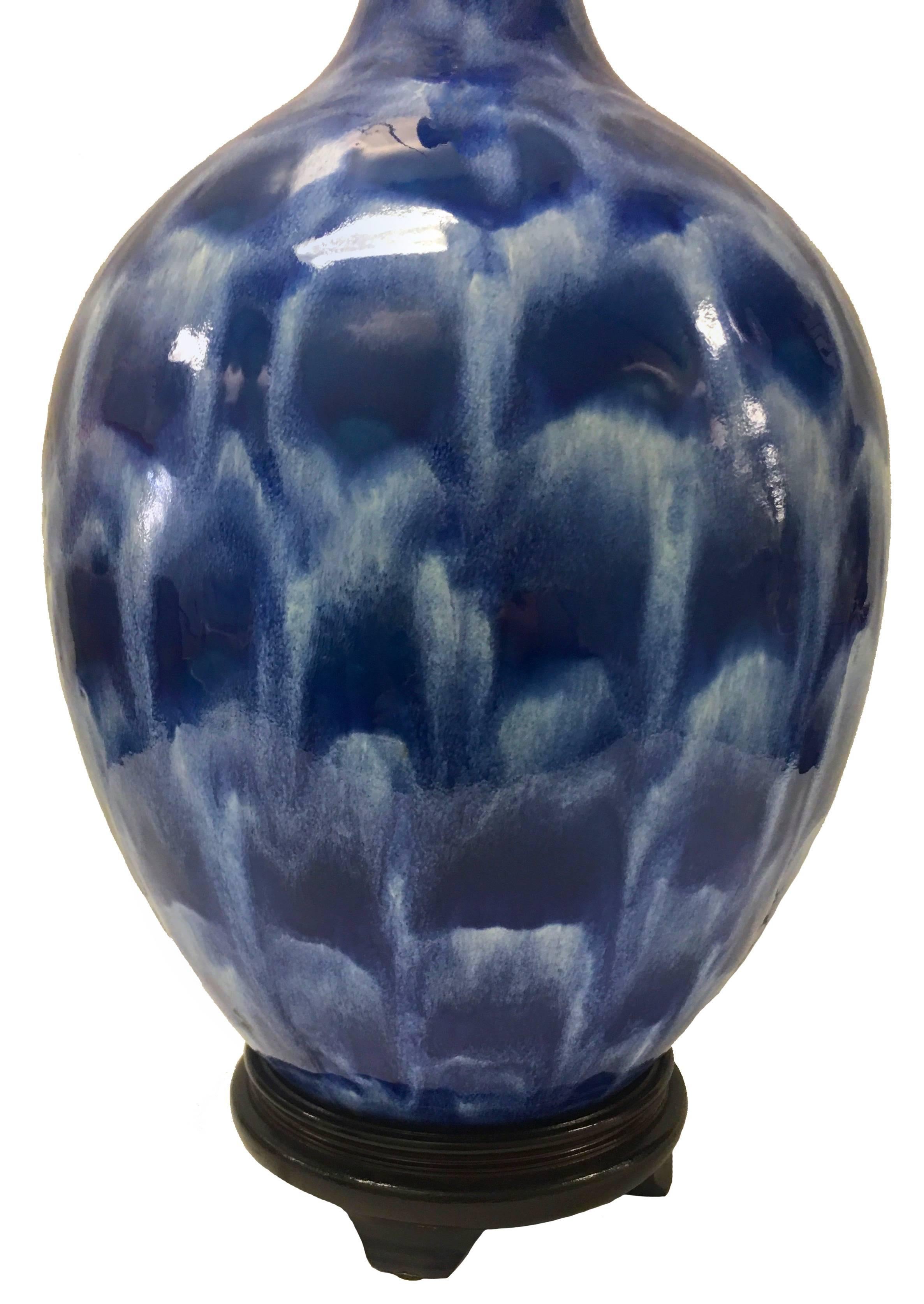 Antique blue sponge ware vase previously converted into a table lamp. Newly rewired with new rosewood base. Takes one standard bulb. Lampshade not included.