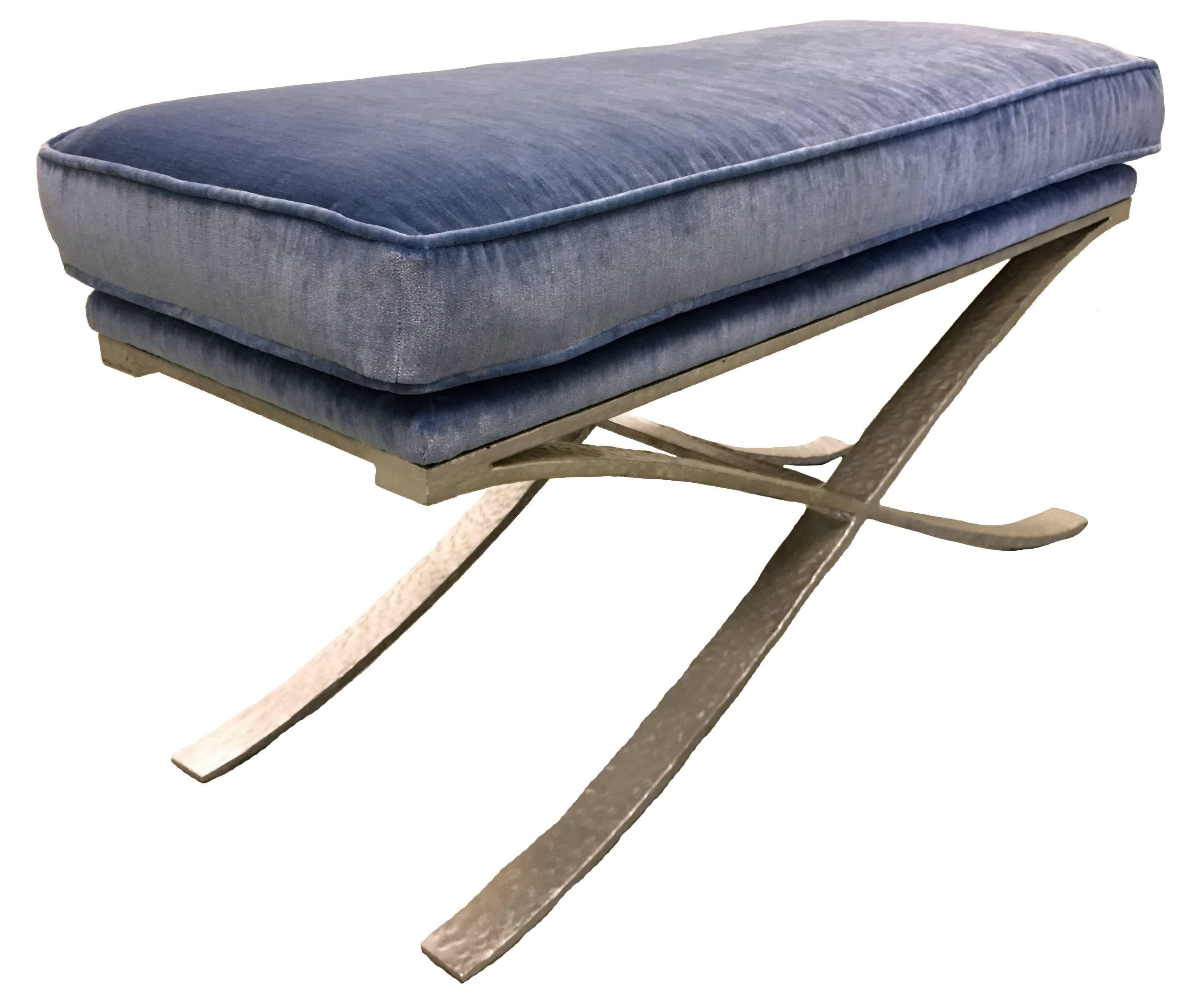 Contemporary silver hammered metal X-bench. Faux silver leaf painted finish over hammered steel frame. Very heavy solid construction. Newly upholstered in Manuel Canovas strie velvet 'Marmande' in Mer (blue).