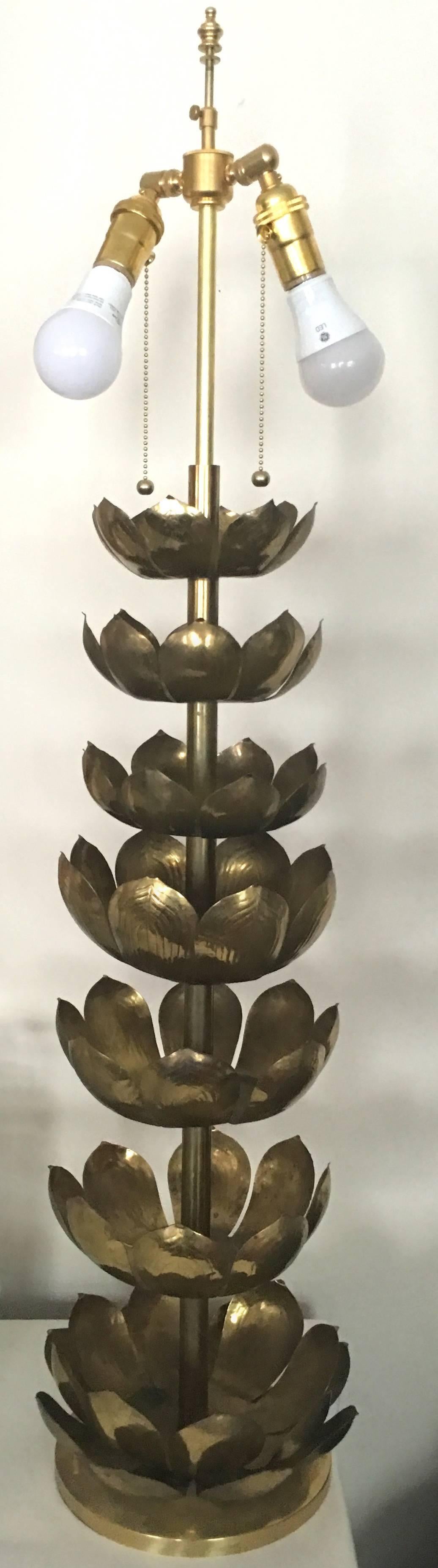 Very tall and statement making brass lotus table lamp by Feldman. Seven brass lotus flowers in descending size. Round brass base and new brass double socket. Lampshade is not included. Newly rewired. Takes two standard bulbs.
Light overall age wear