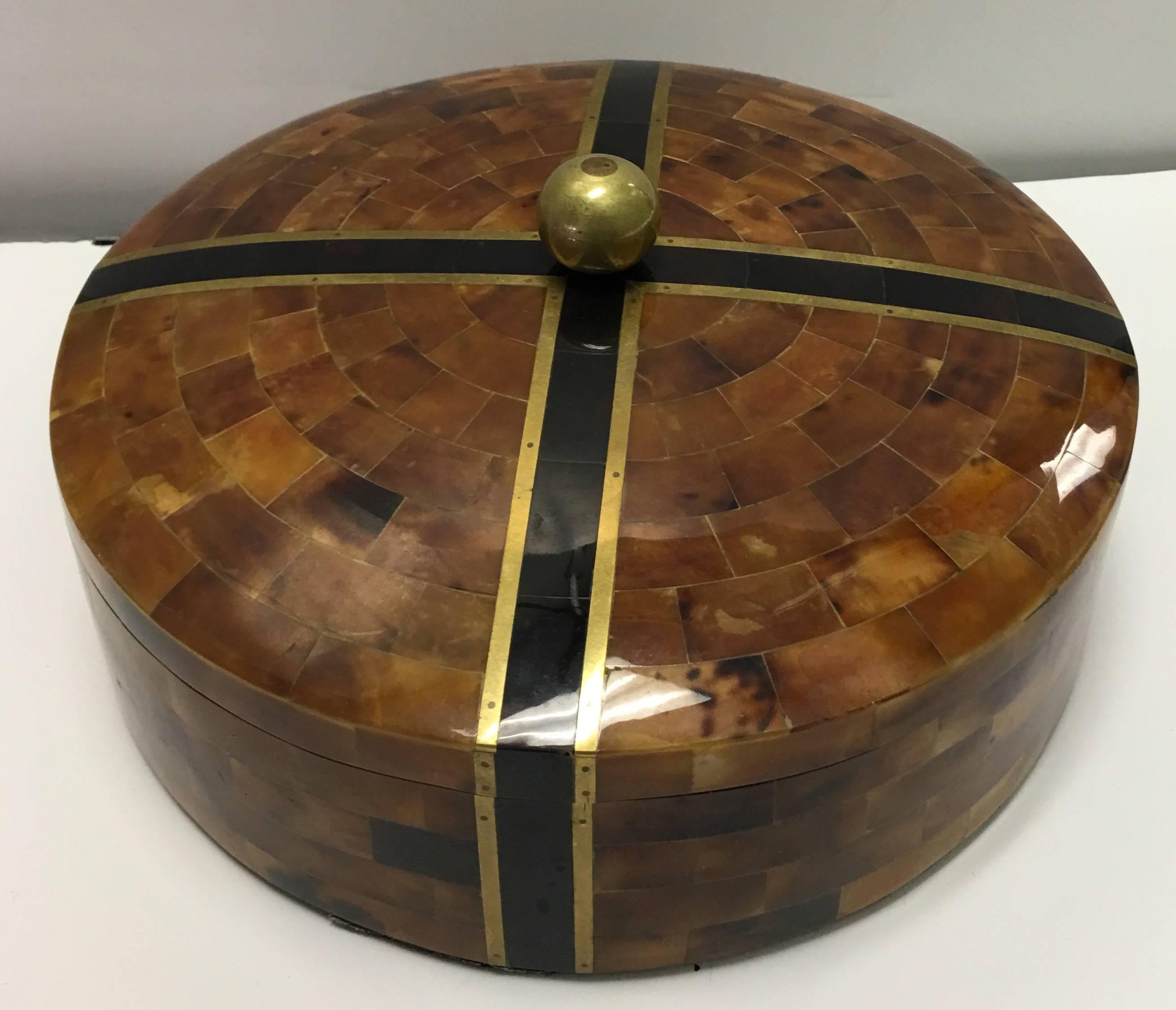 Maitland-Smith round pen shell box. Mahogany wood with brown pen shell overlay and brass accents. Round brass finial. No makers mark/ signature.
