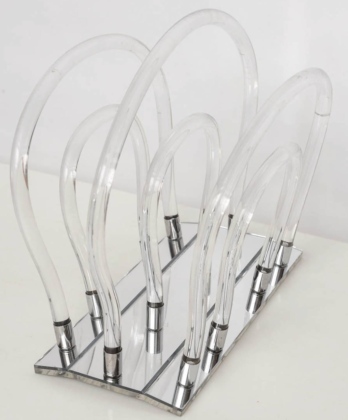 Dorothy Thorpe Lucite magazine holder. Lucite with chrome accents and mirrored base.