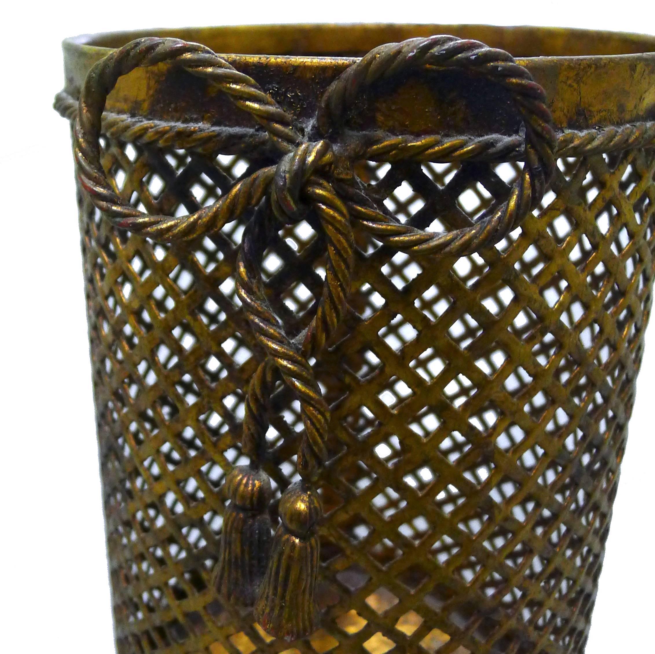 Italian gilt metal wastepaper basket. Rope bow with tassel accent. Signed Made in Italy.