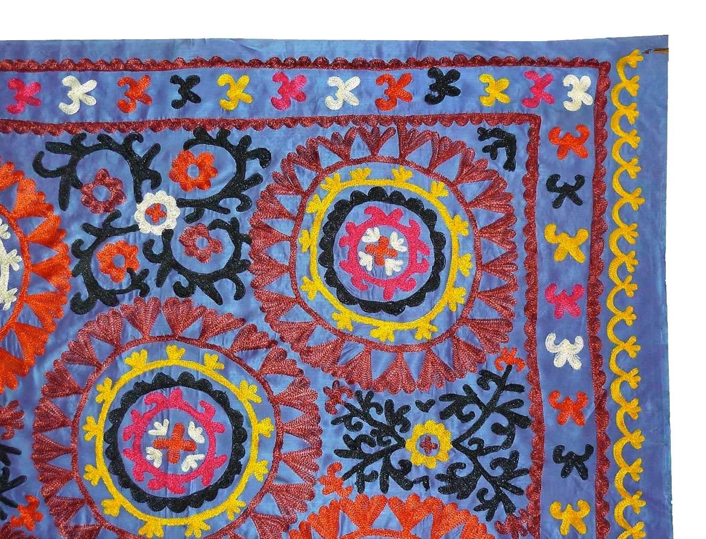 Large Uzbek embroidered Suzani light blue silk background with silk embroidery. This extraordinary textile measures 60" x 50" and is in good vintage condition.