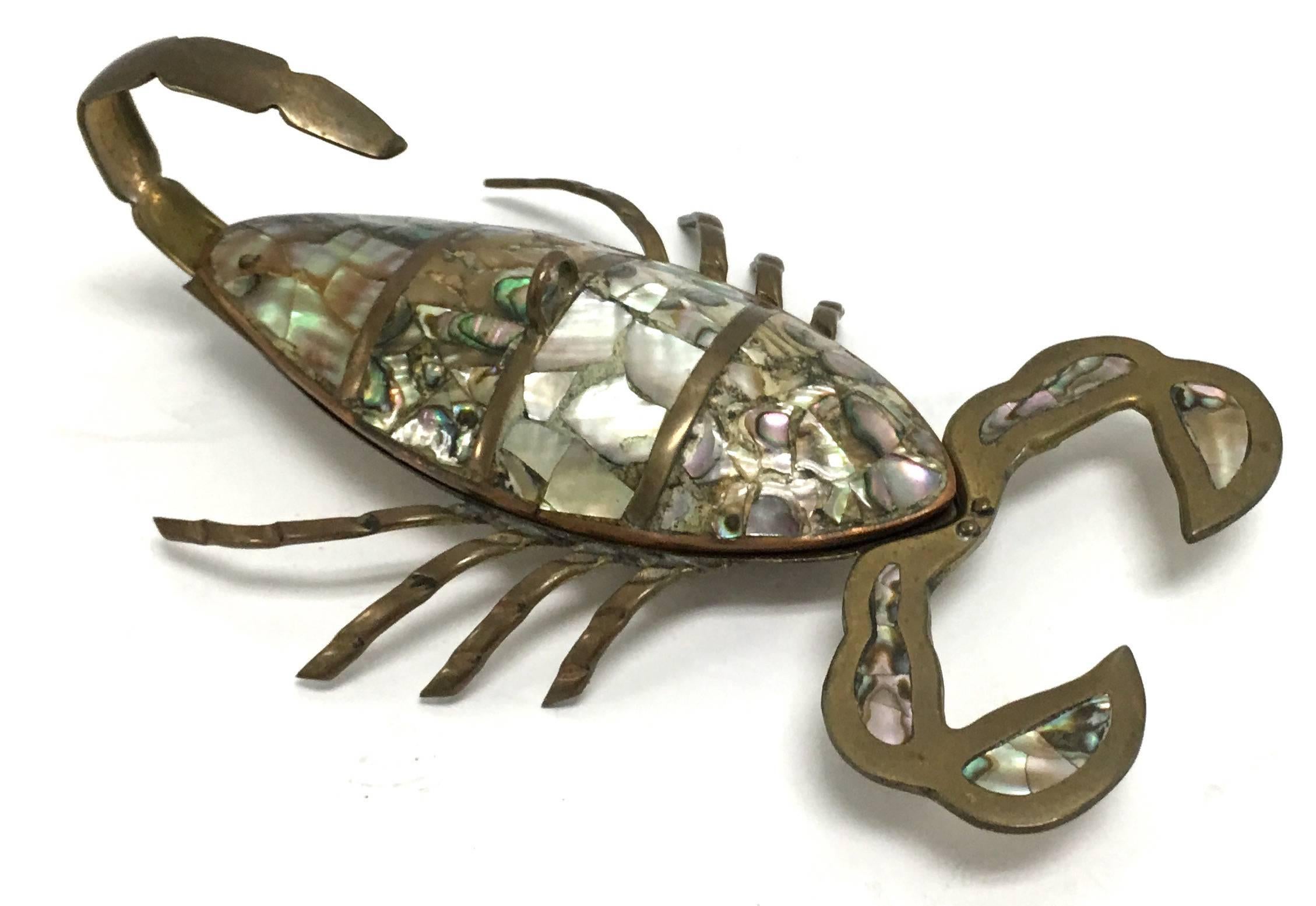 Set of two Mexican brass scorpions. Hand-wrought brass with abalone inlay. Smaller scorpion. Measures 5.5