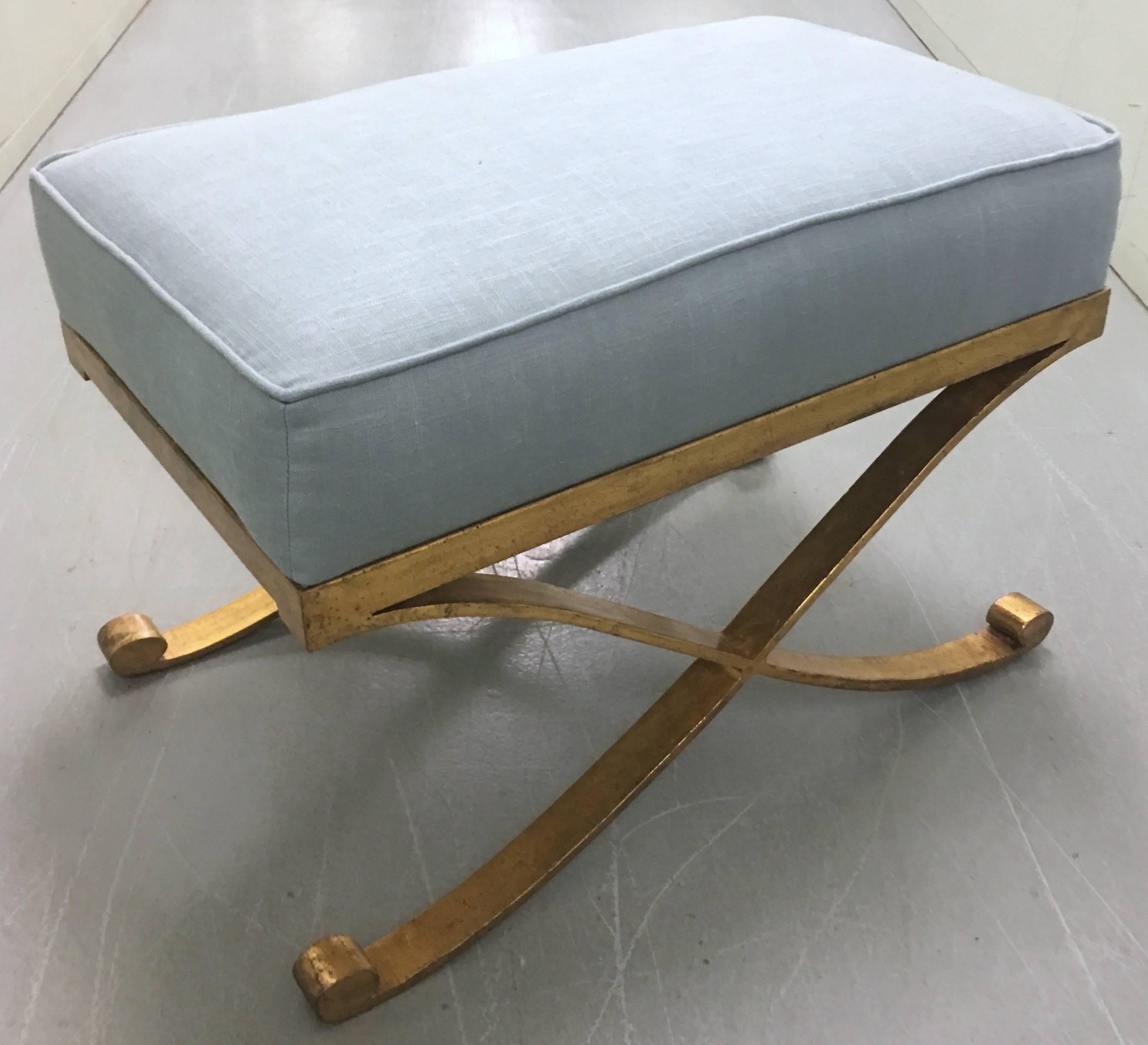 Hammered brass bench by Mastercraft for Baker. In the style of Raymond Subes. Newly upholstered in light blue linen fabric by Rogers & Goffigon. Very heavy solid brass construction with lightly hammered finish. Stool retains Baker label.