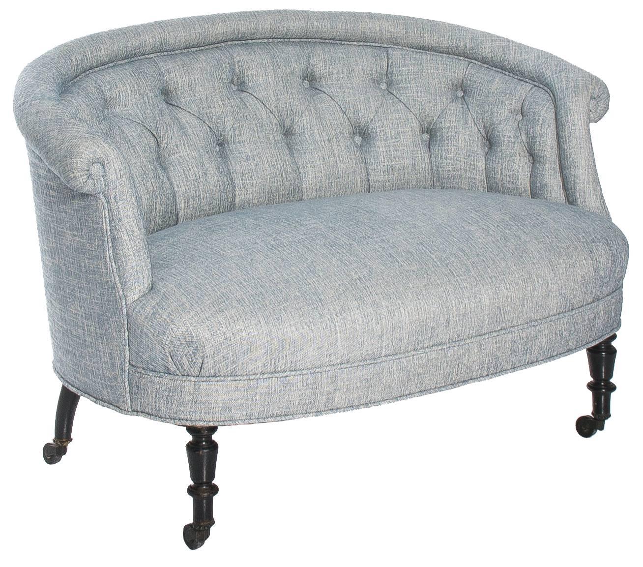 Petite French Napoleon III round scroll back sofa, circa 1880s. Turned black legs with original castors. Newly upholstered in Manuel Canovas 'Marius' in Ciel (light blue and white) linen.