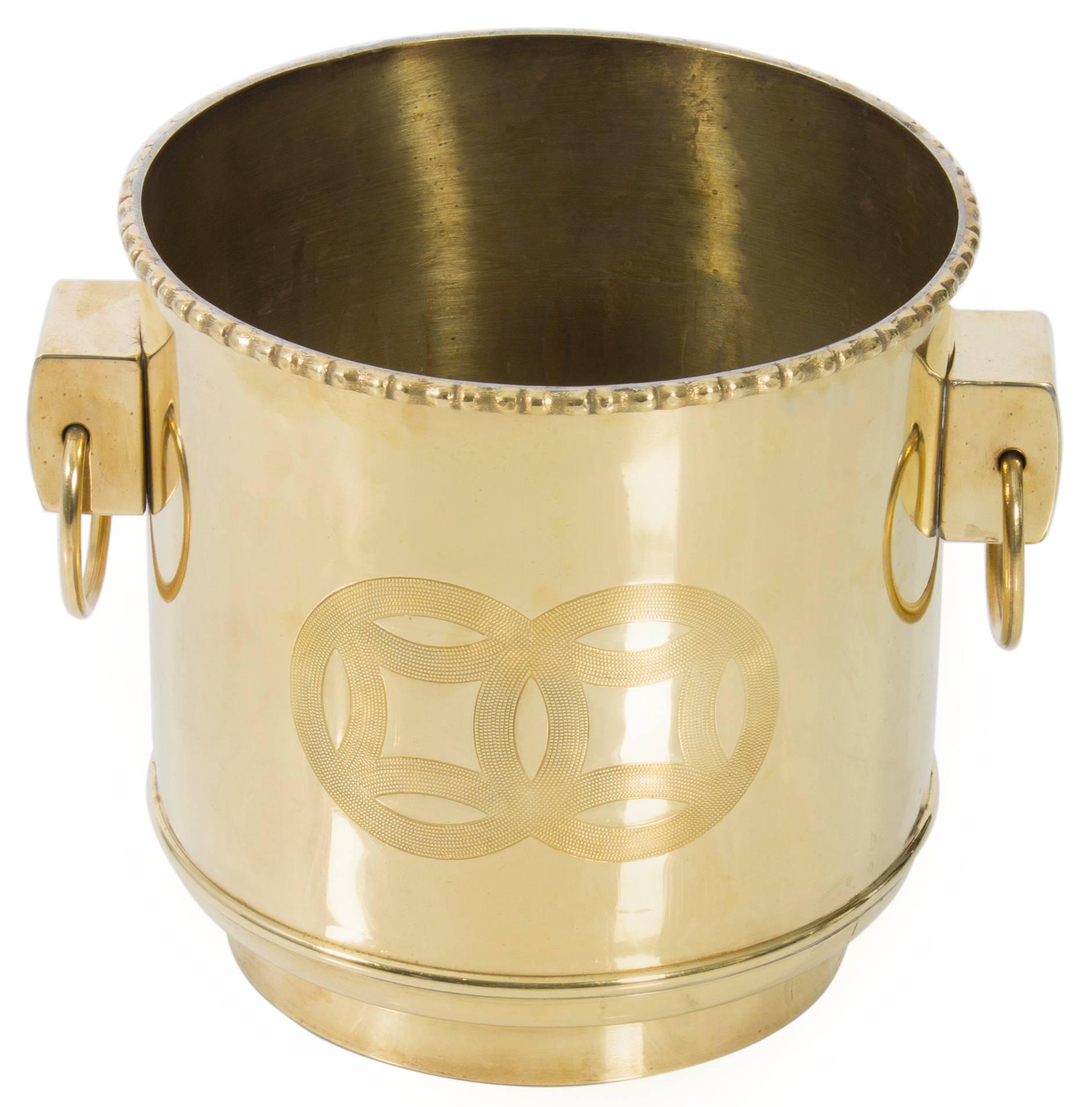 Pair of chinoiserie polished brass round planters. Each planter has double ring pulls and etched chinoiserie motif.
