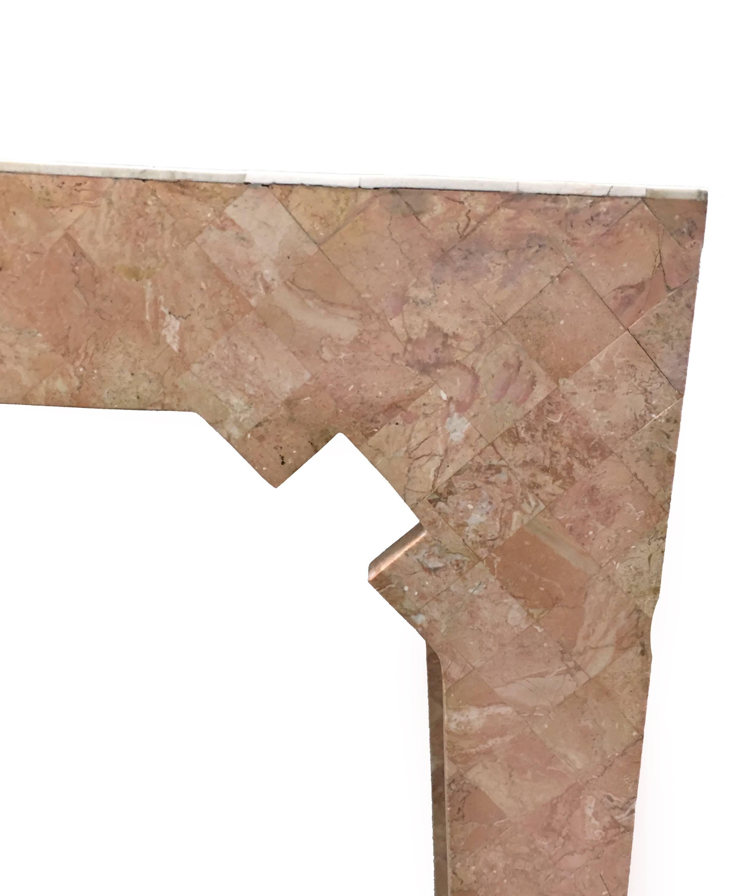 Pink tessellated stone console table by Maitland Smith. Beige stone feet and geometric detailing. No makers mark. 
 