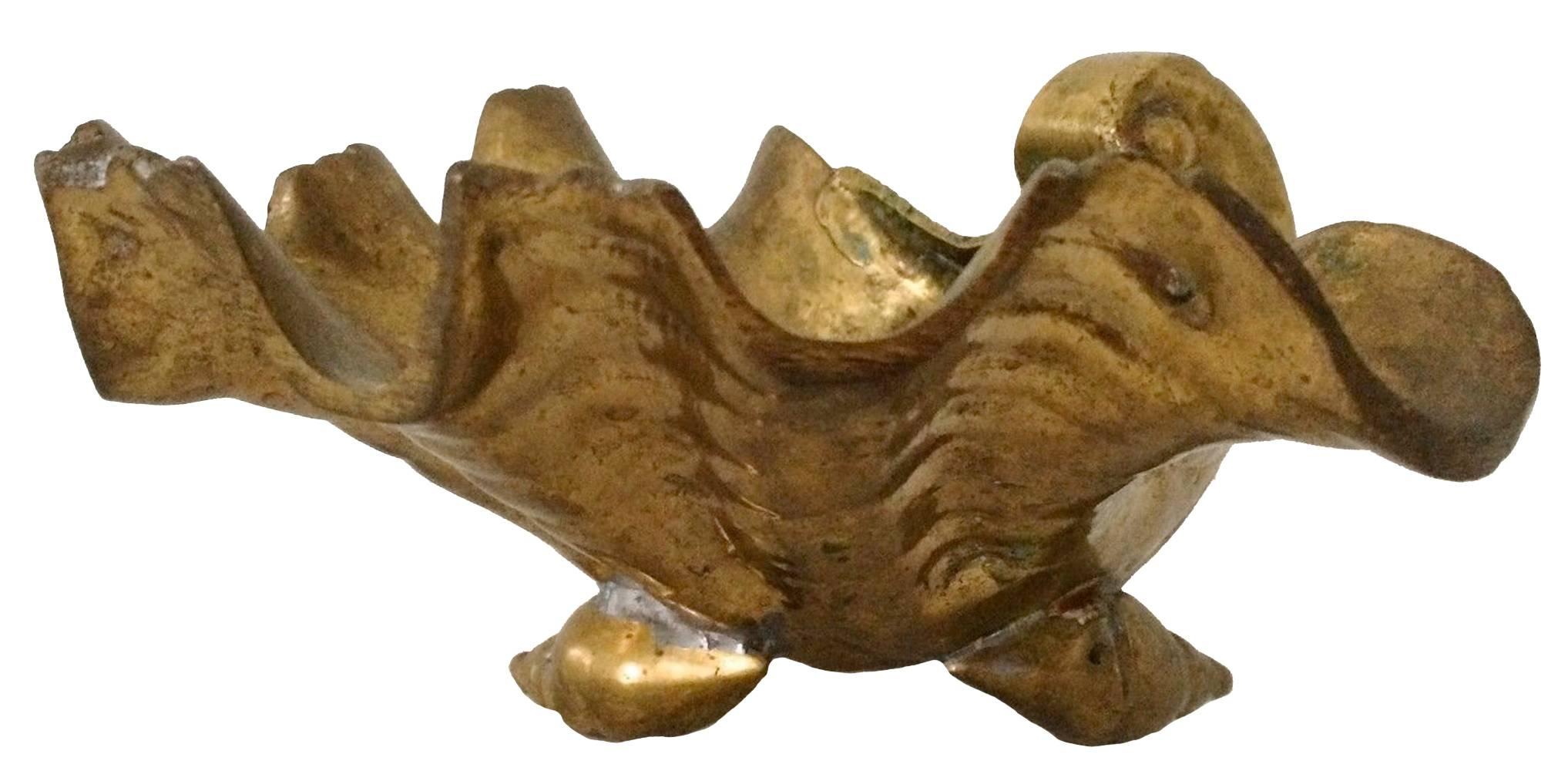 Hollywood Regency solid cast brass shell bowl on three shell feet. Overall unpolished patina.